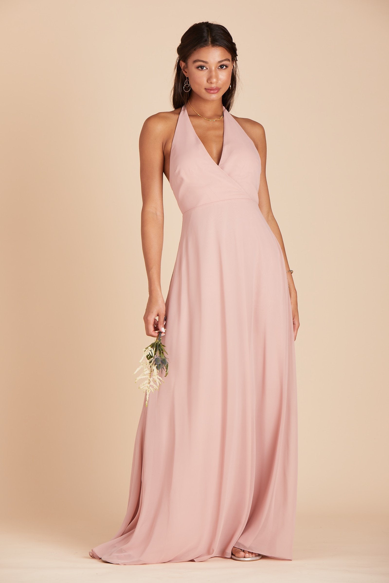 Front view of a floor length dress in dusty rose chiffon worn by a slender model with a light skin tone. 