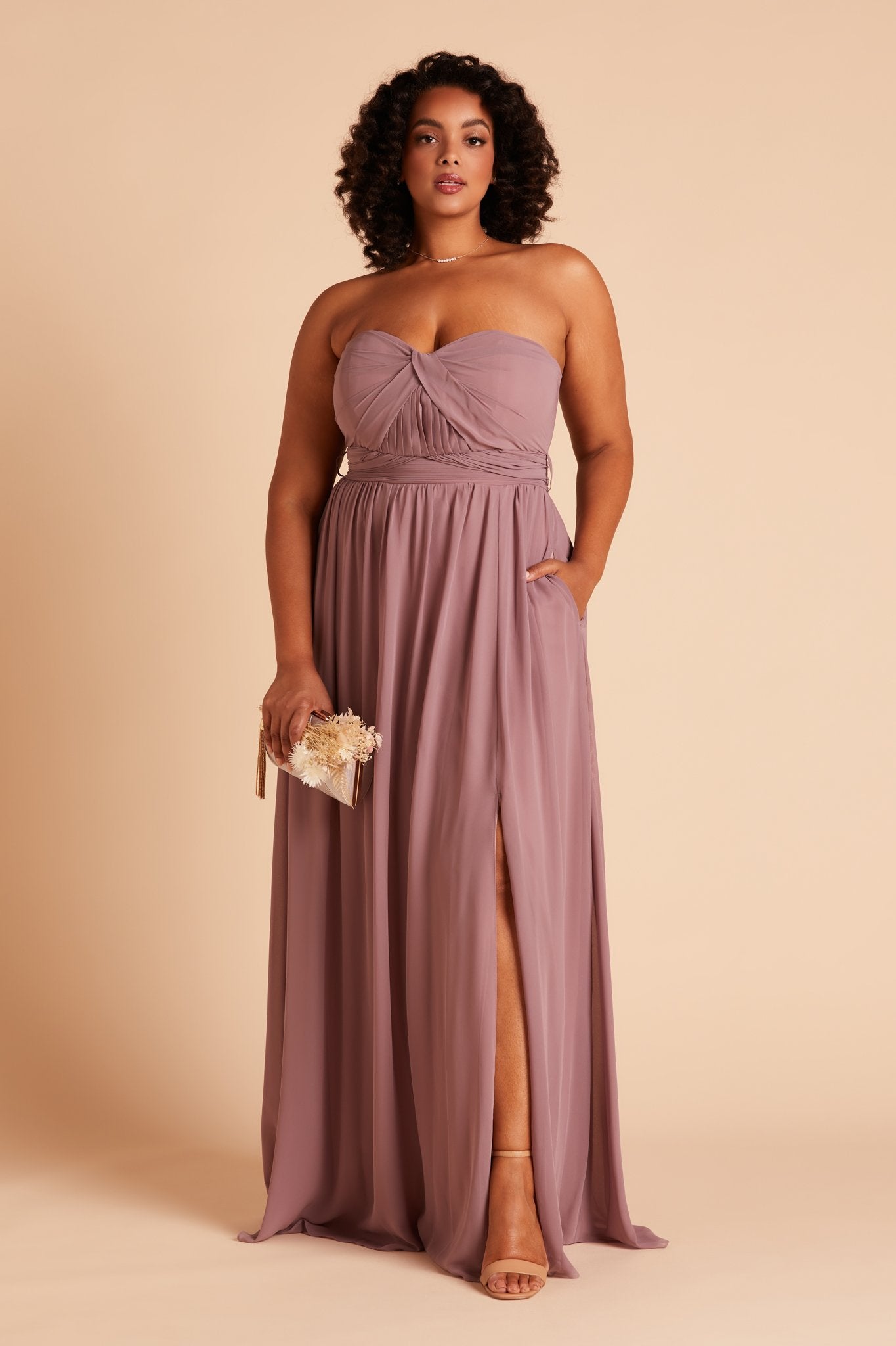 Grace convertible plus size bridesmaid dress with slit in dark mauve chiffon by Birdy Grey, front view with hand in pocket