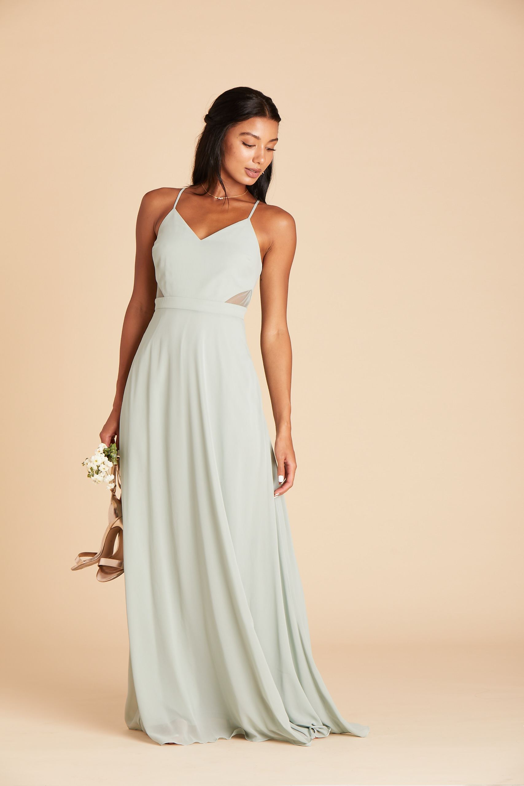Front view of a floor length dress in sage chiffon worn by a slender model with a light skin tone. 