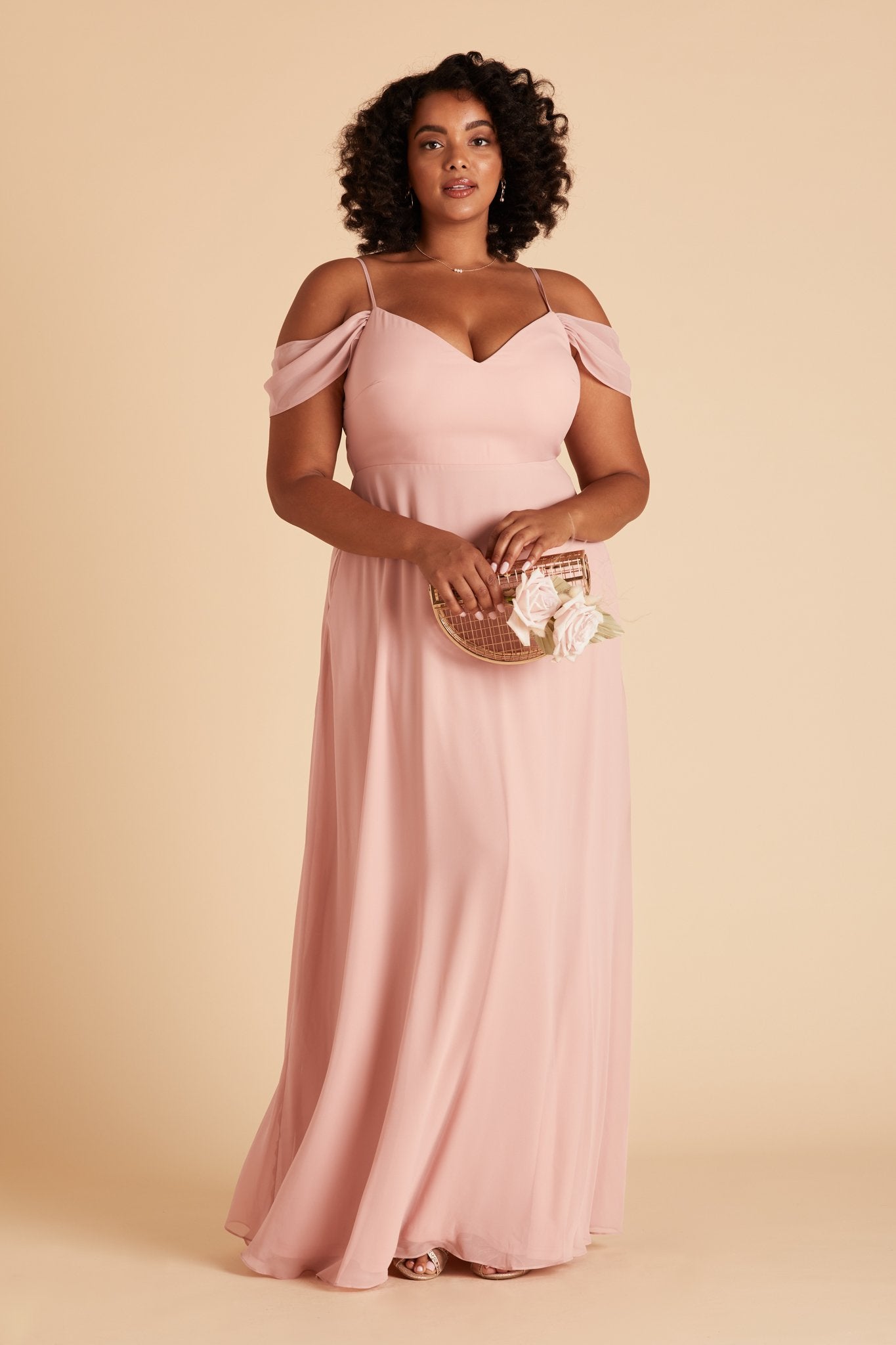 Front view of the Devon Convertible Dress Curve in dusty rose chiffon worn by a full-figured model with a medium skin tone. 