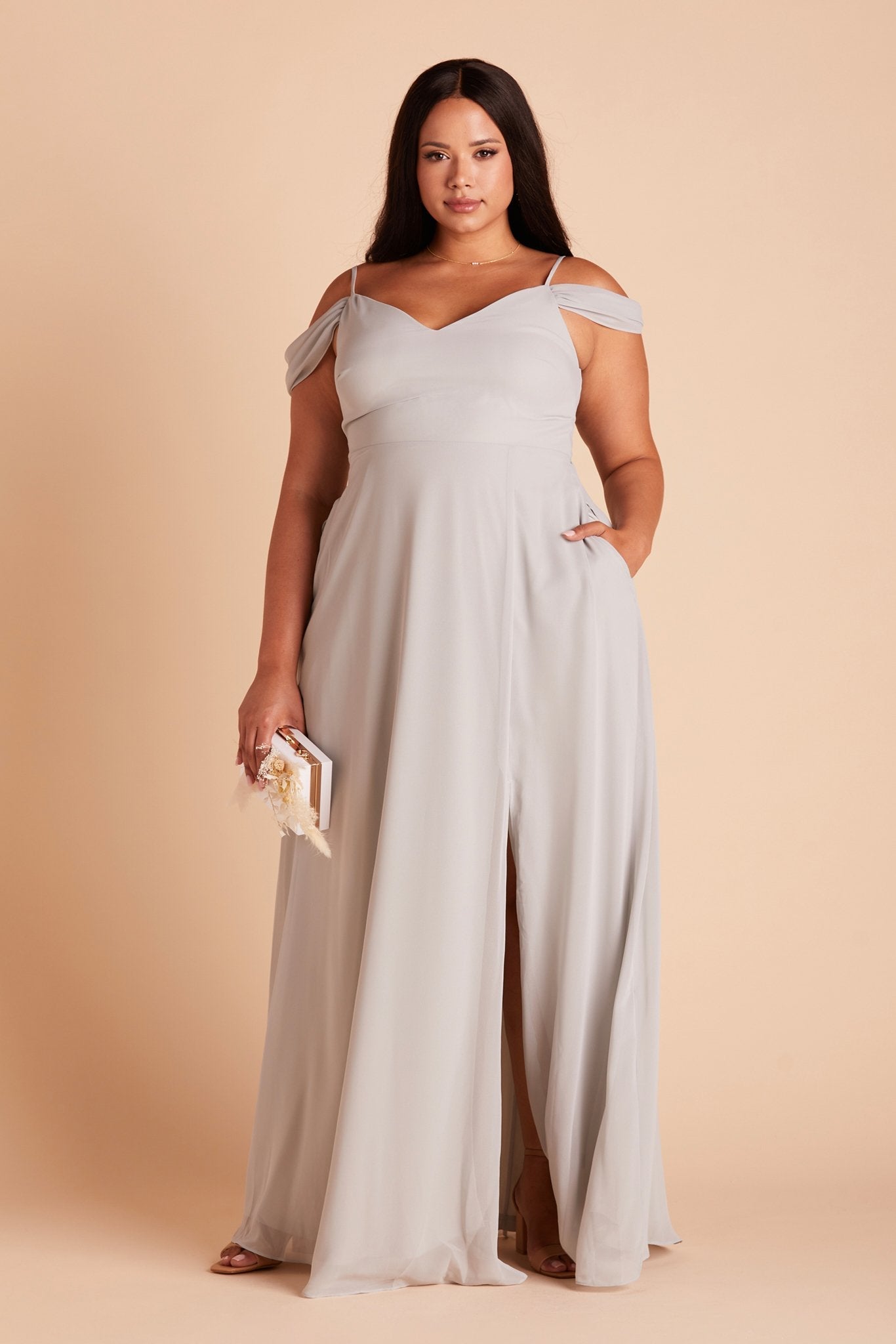 Devin convertible plus size bridesmaid dress with slit in dove gray chiffon by Birdy Grey, front view with hand in pocket