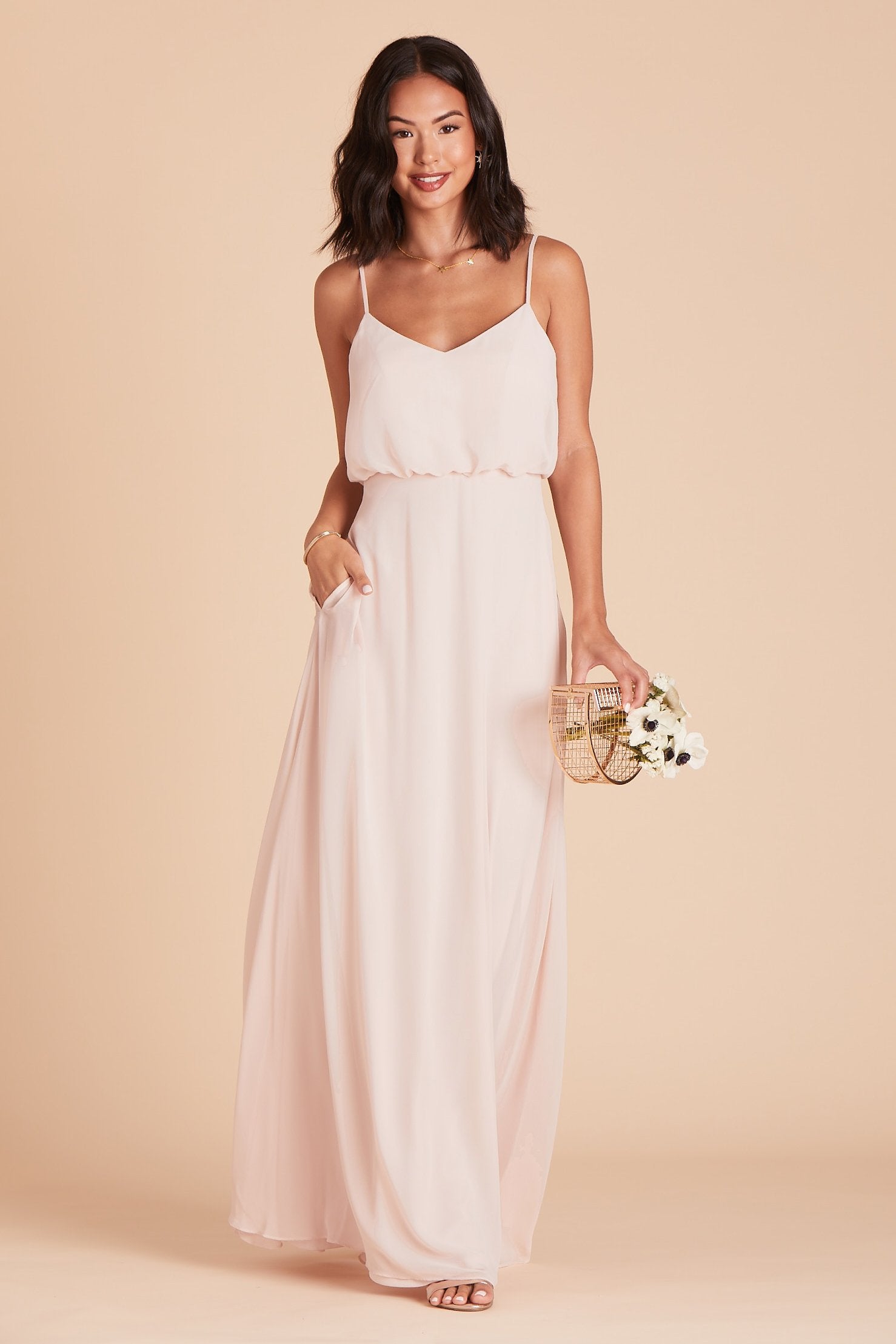 Gwennie bridesmaid dress in pale blush chiffon by Birdy Grey, front view with hand in pocket