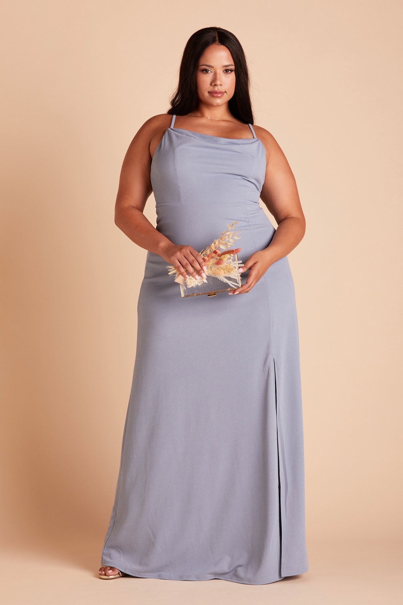 Front view of the floor-length Ash Plus Size Bridesmaid Dress in dusty blue crepe worn by a curvy model with medium-tone skin.