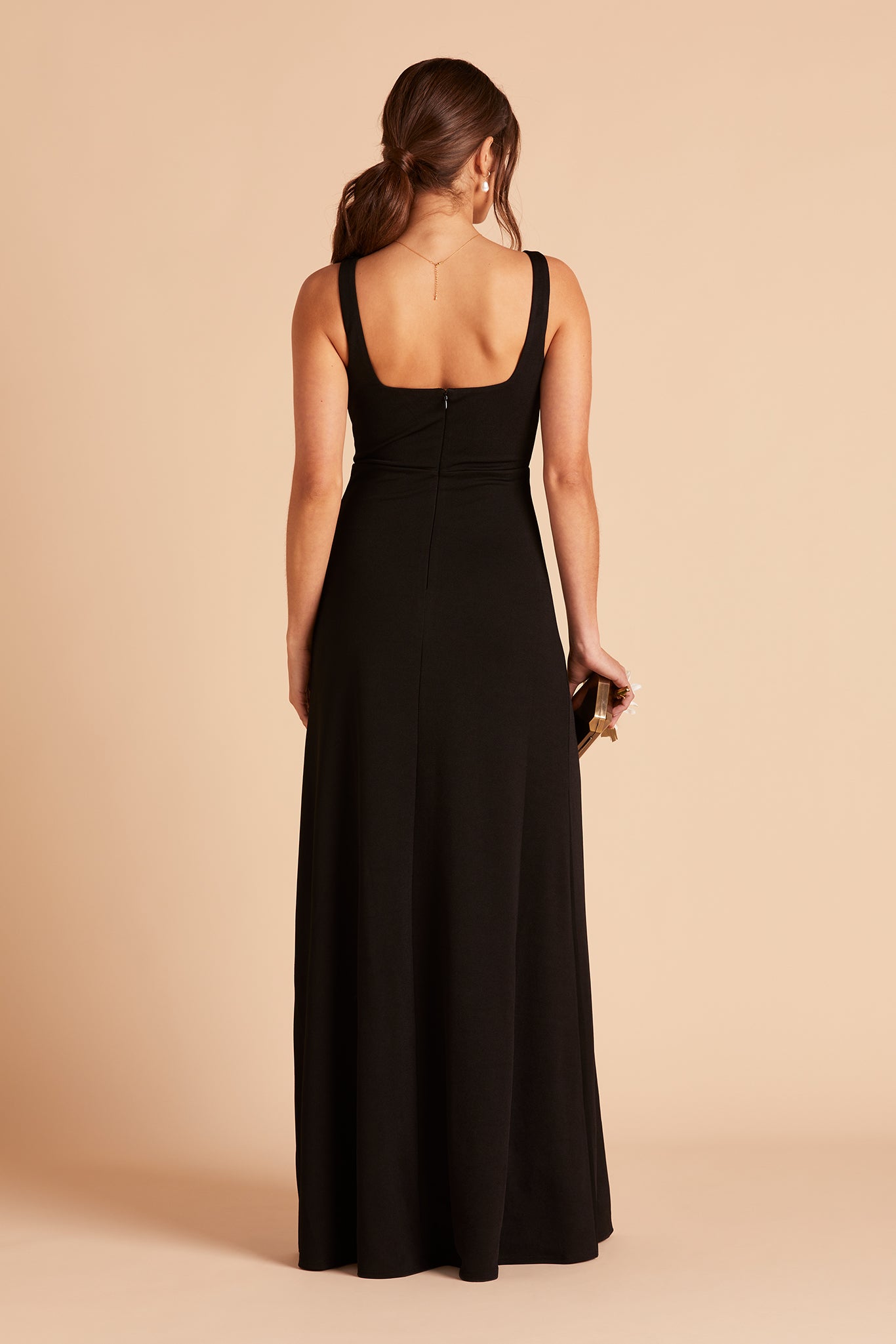 Back view of the Alex Convertible Bridesmaid Dress in black crepe shows that the shoulder ties feature a square cut that falls just below the shoulder blades.