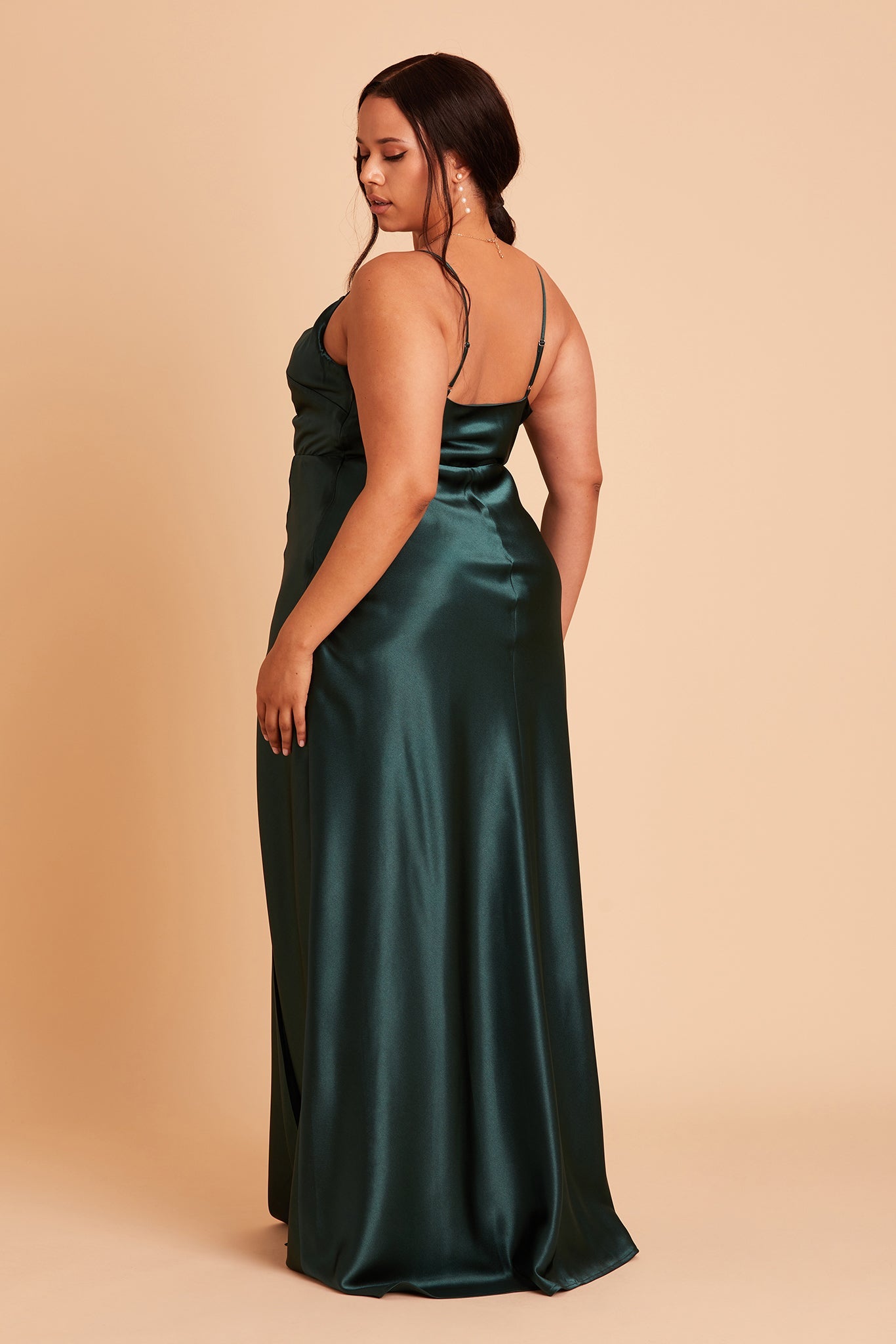 Back view of the Lisa Long Dress Curve in emerald satin shows the back of the dress with adjustable spaghetti straps and a smooth fit in the bodice and waist that attach to a full length skirt.  