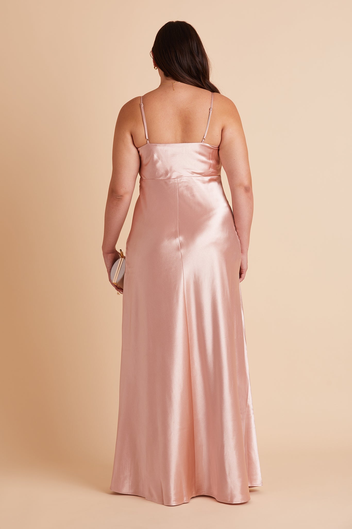 Back view of the Lisa Long Dress Curve Plus Size in rose gold satin shows the back of the dress with adjustable spaghetti straps and a smooth fit in the bodice and waist that attach to a full length skirt.  