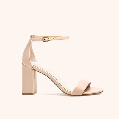 Side view of the Mary High Chunky Heel shoe in nude blush in vegan leather with an open toe, enclosed heel, a three and one third inch block chunky heel, and adjustable buckle ankle strap. 