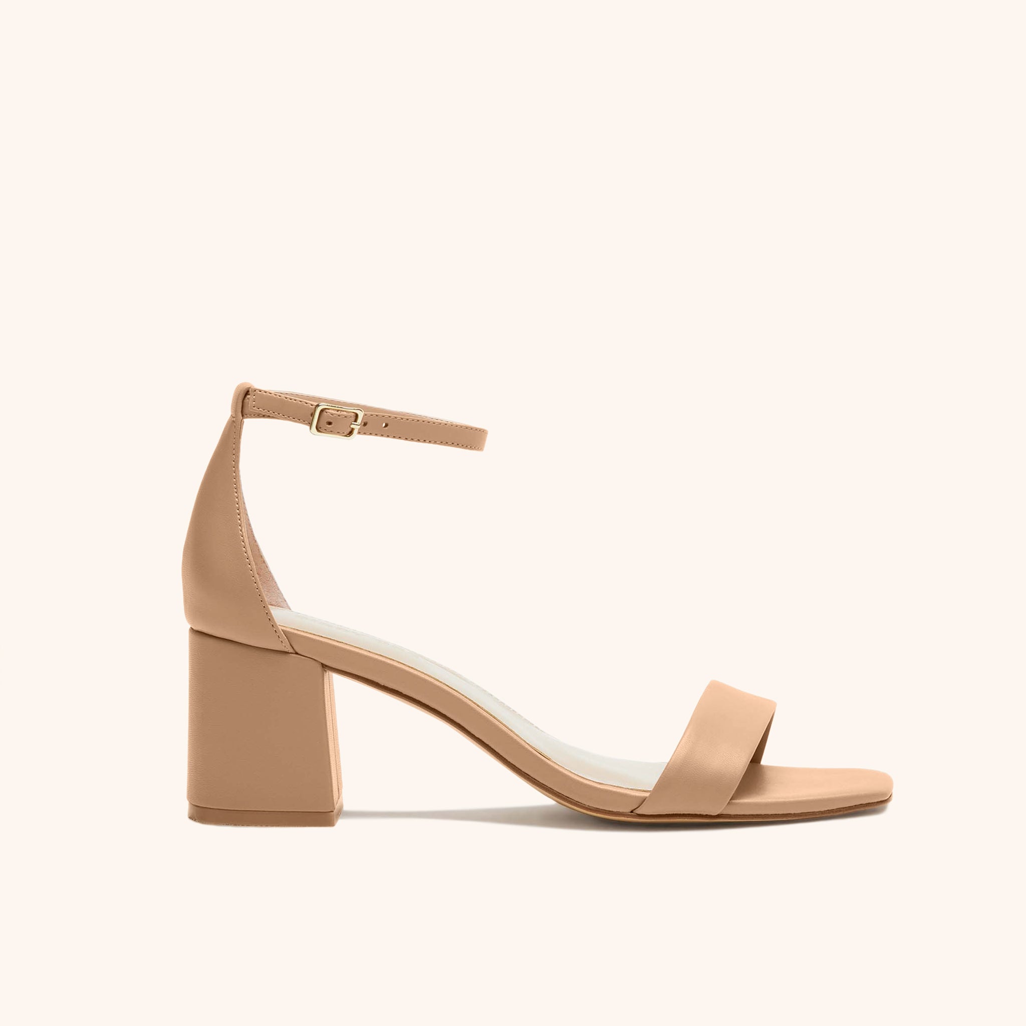 Side product view of the Natalie Chunky Heel shoe in nude latte in vegan leather with open toe, enclosed heel, a two and one half inch block chunky heel, and adjustable buckle ankle strap. 