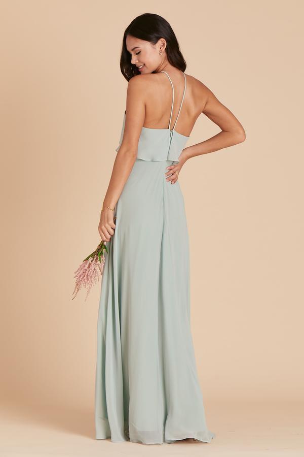 Back view of the Jane Convertible Dress in sage chiffon worn by a slender model with a light skin tone. 