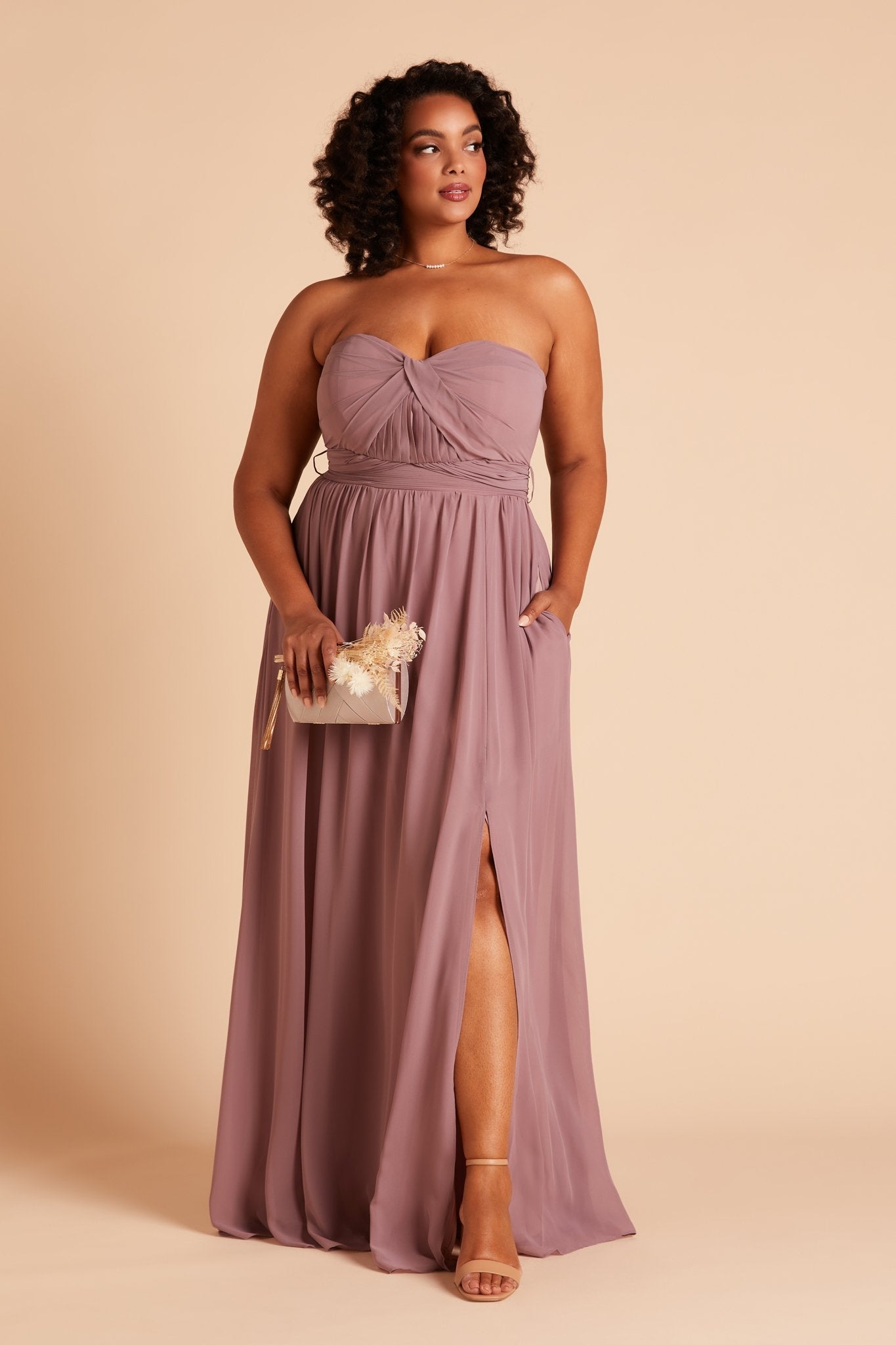 Grace convertible plus size bridesmaid dress with slit in dark mauve chiffon by Birdy Grey, front view with hand in pocket