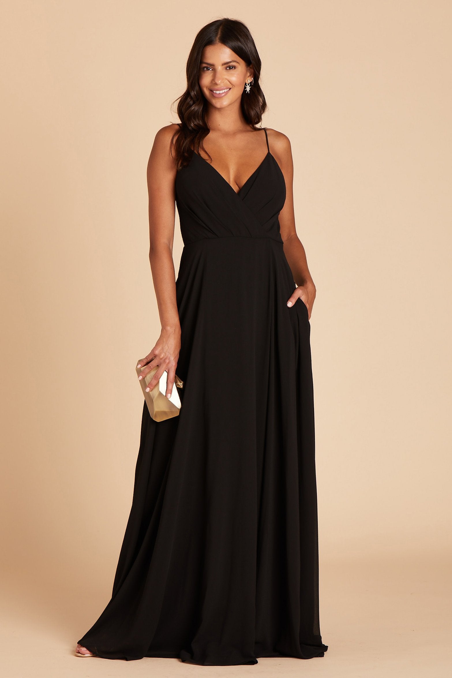 Kaia bridesmaids dress in black chiffon by Birdy Grey, front view with hand in pocket