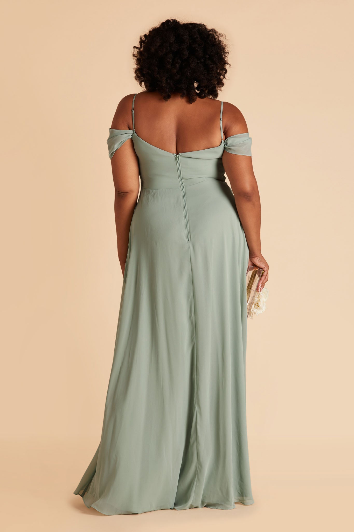 Back view of the floor-length Devin Convertible Plus Size Bridesmaid Dress features a fitted bust and waist with a flowing skirt that moves with the model.