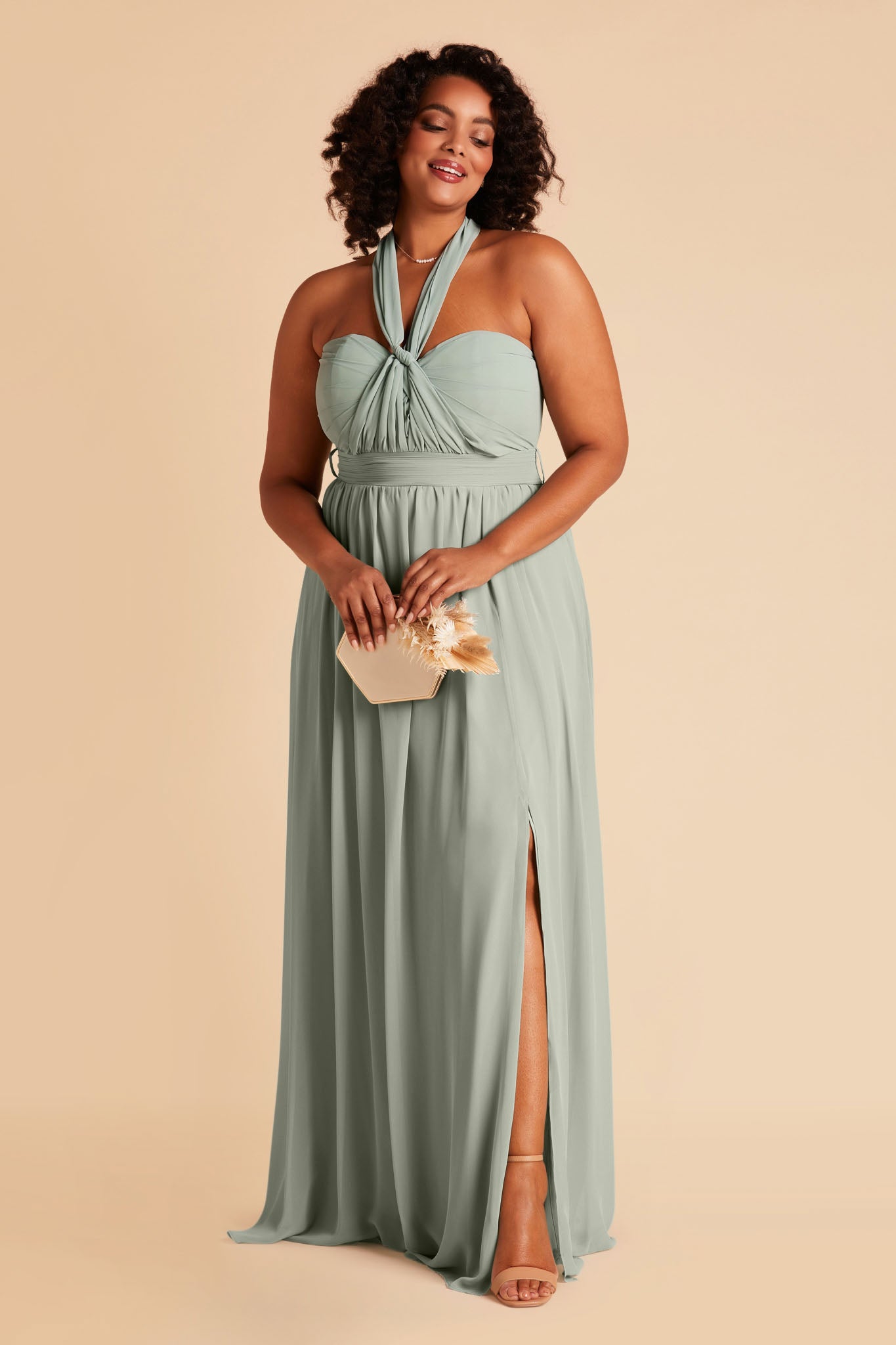 Front view of the floor-length Grace Convertible Plus Size Bridesmaid Dress in sage chiffon with the front streamers tied at the center of the sweetheart neckline, then pulled back over each shoulder to form an x-neckline.
