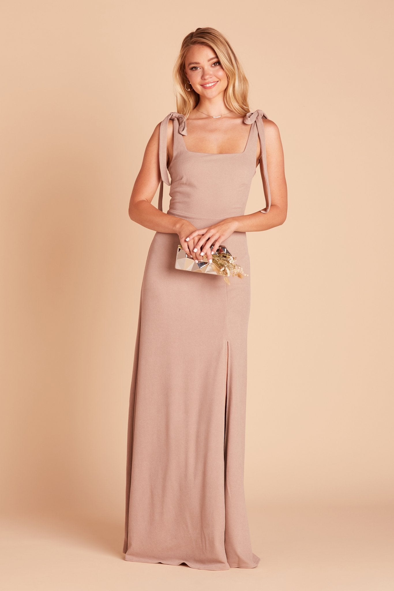 Front view of the Alex Convertible Bridesmaid Dress in taupe with shoulder ties that are tied in a bow and draped down over each shoulder.