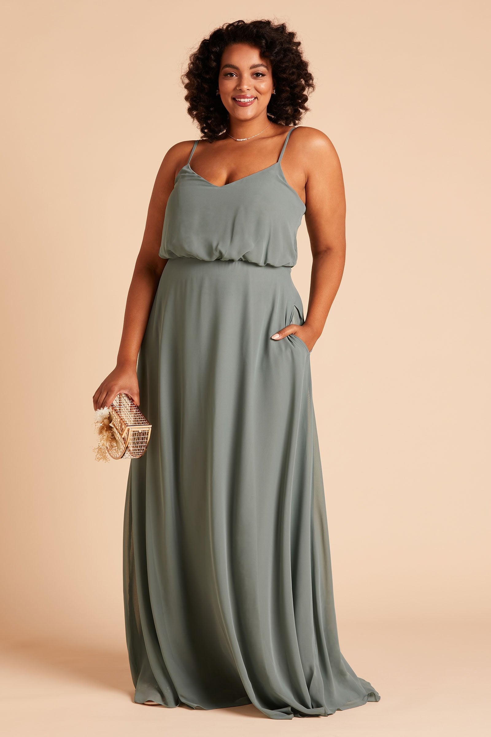 Gwennie plus size bridesmaid dress in sea glass green chiffon by Birdy Grey, front view with hand in pocket