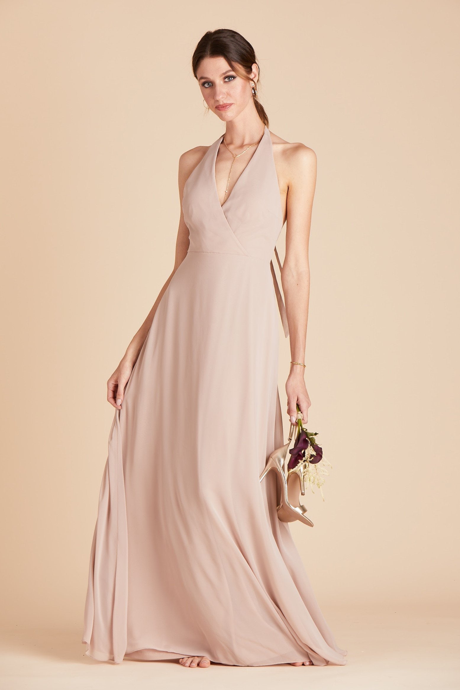 Front view of a floor length dress in taupe chiffon worn by a slender model with a light skin tone. 