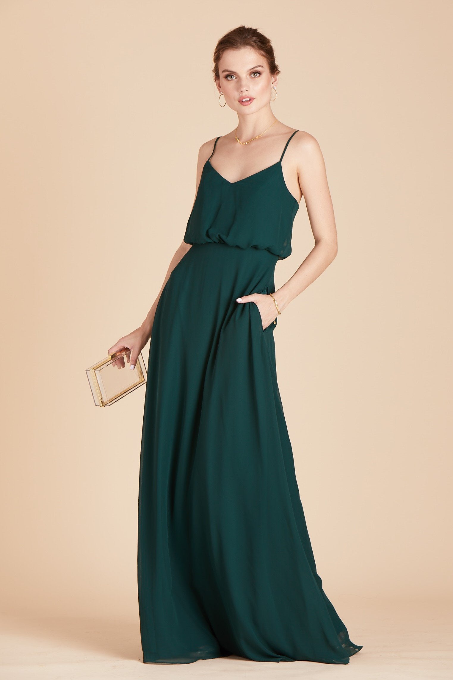 Gwennie bridesmaid dress in emerald green chiffon by Birdy Grey, front view with hand in pocket