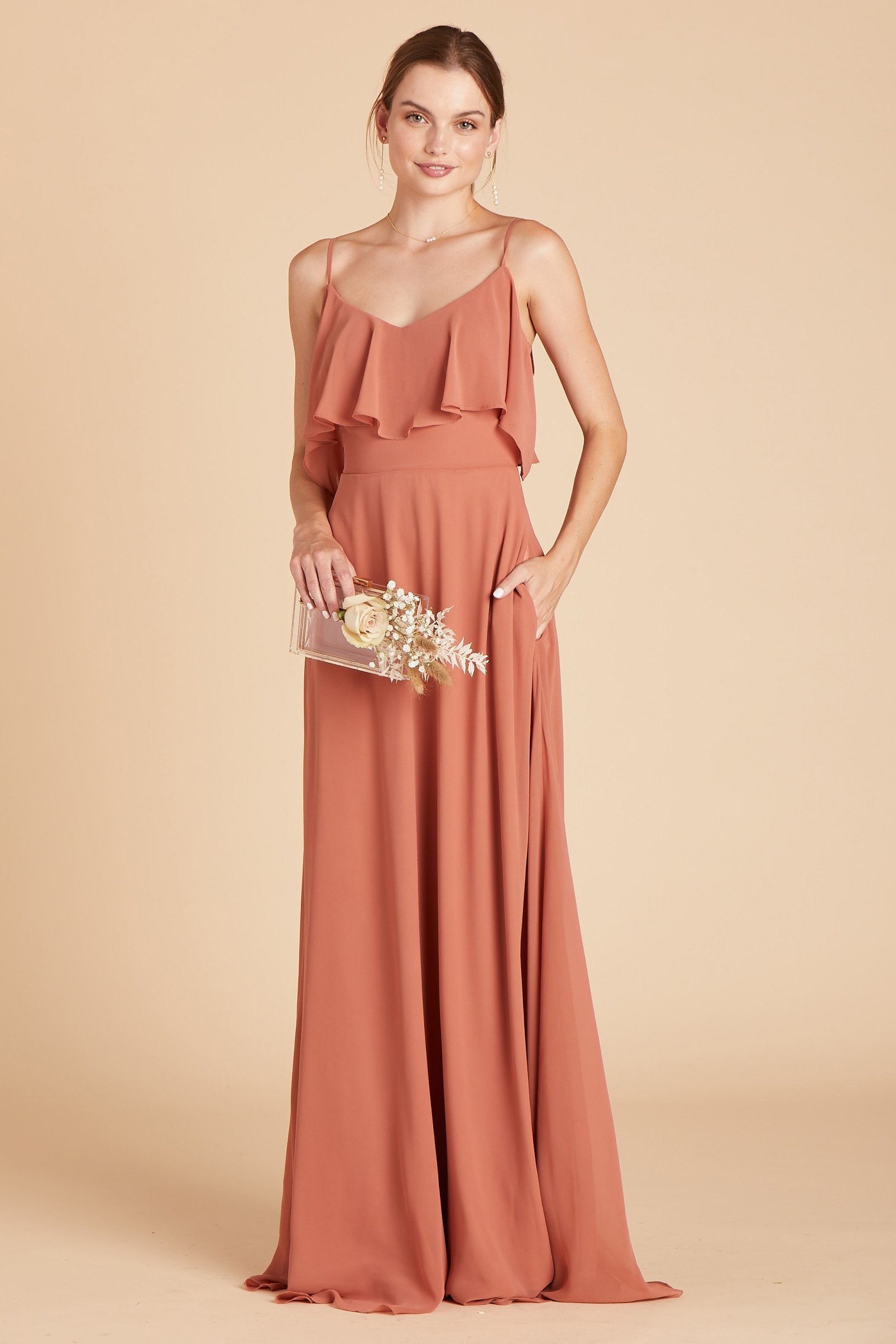 Jane convertible bridesmaid dress in terracotta orange chiffon by Birdy Grey, front view with hand in pocket
