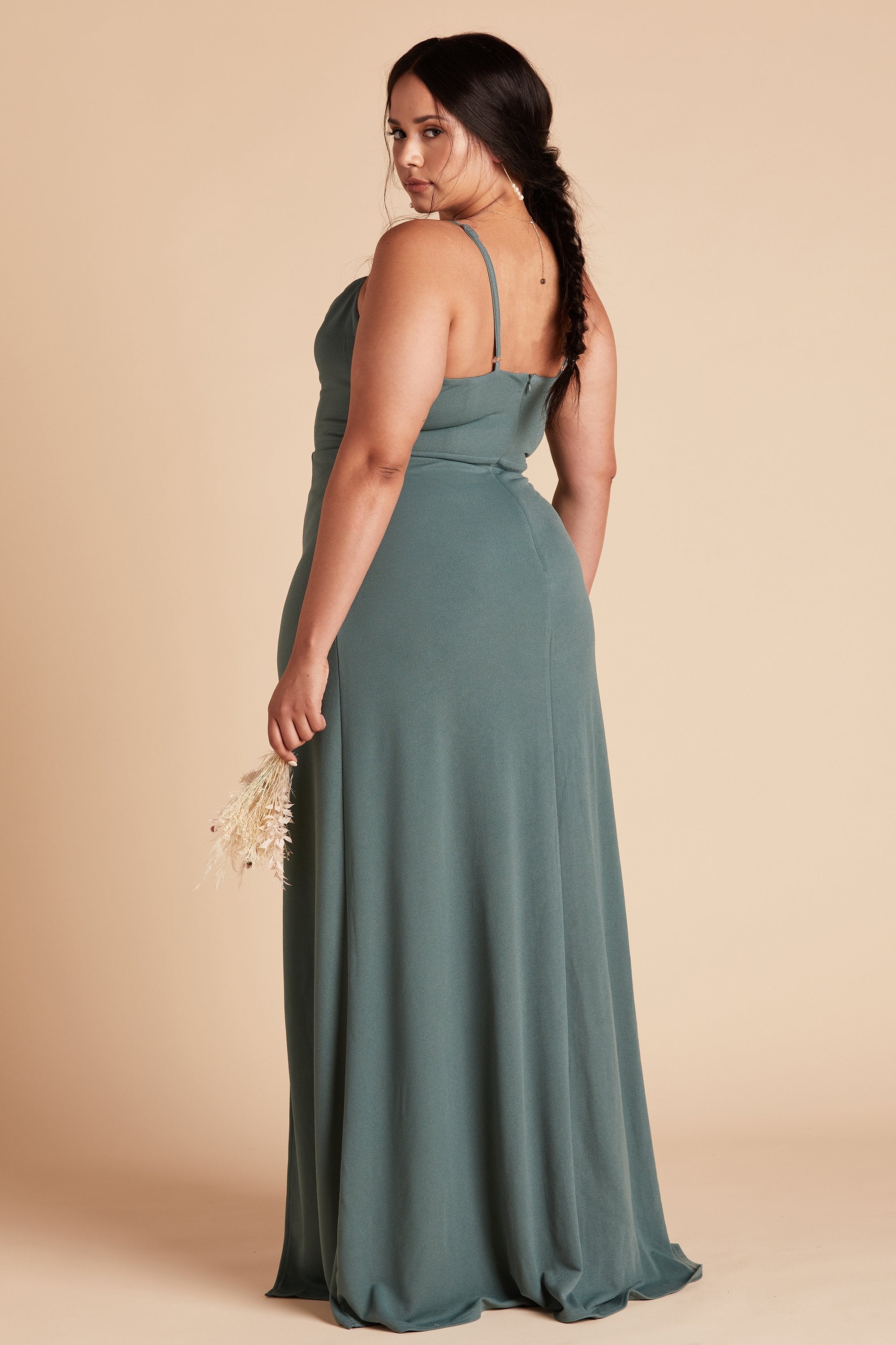 Back view of the Ash Plus Size Bridesmaid Dress in sea glass crepe shows off a cut that flatters curves with a fitted waist and flowing skirt.