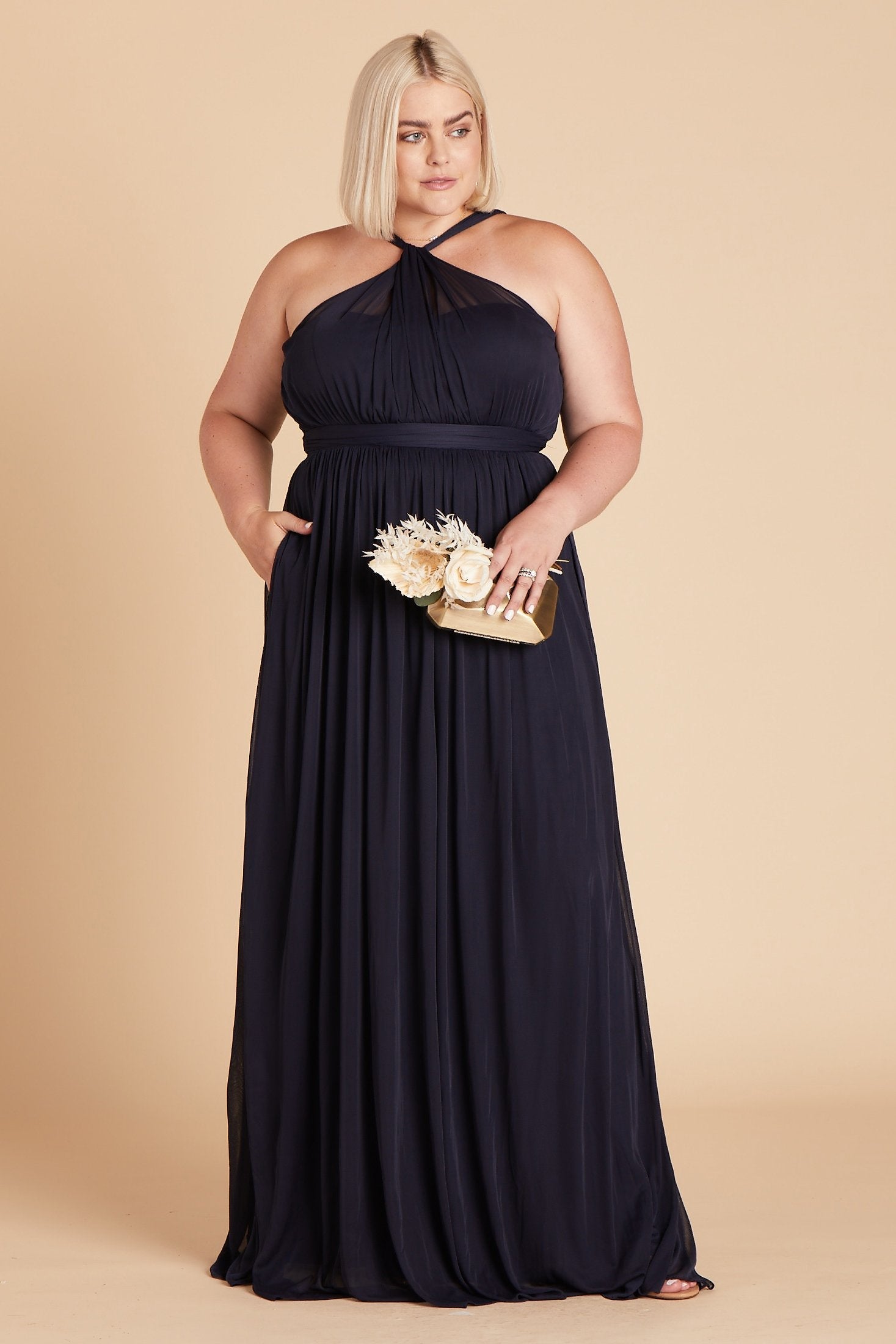 Kiko plus size bridesmaid dress in navy blue chiffon by Birdy Grey, front view with hand in pocket