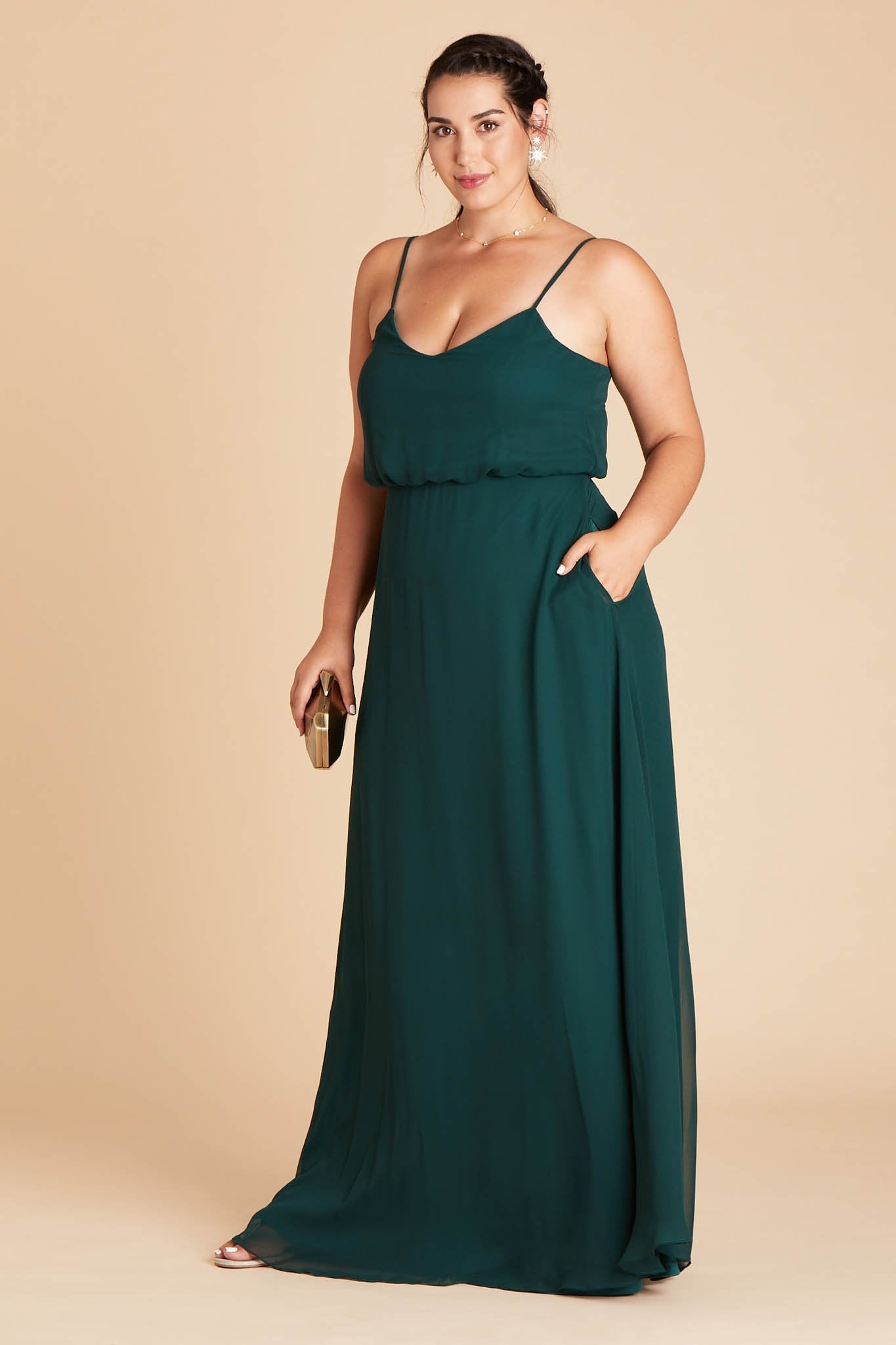 Gwennie plus size bridesmaid dress in emerald green chiffon by Birdy Grey, side view with hand in pocket