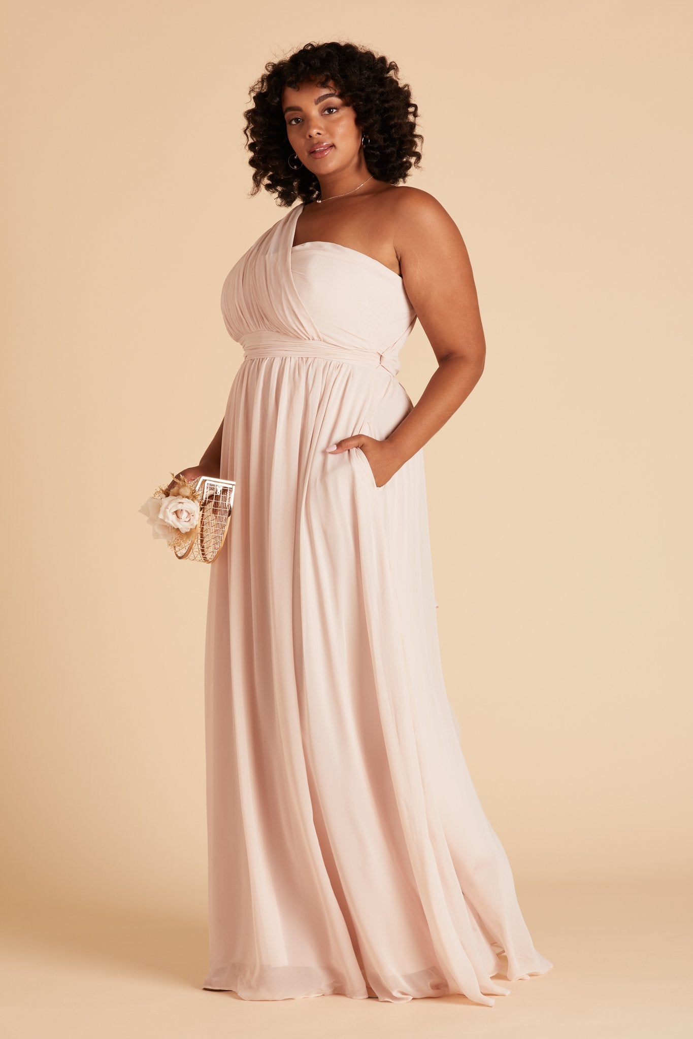 Grace convertible plus size bridesmaid dress in pale blush pink chiffon by Birdy Grey, front view with hand in pocket