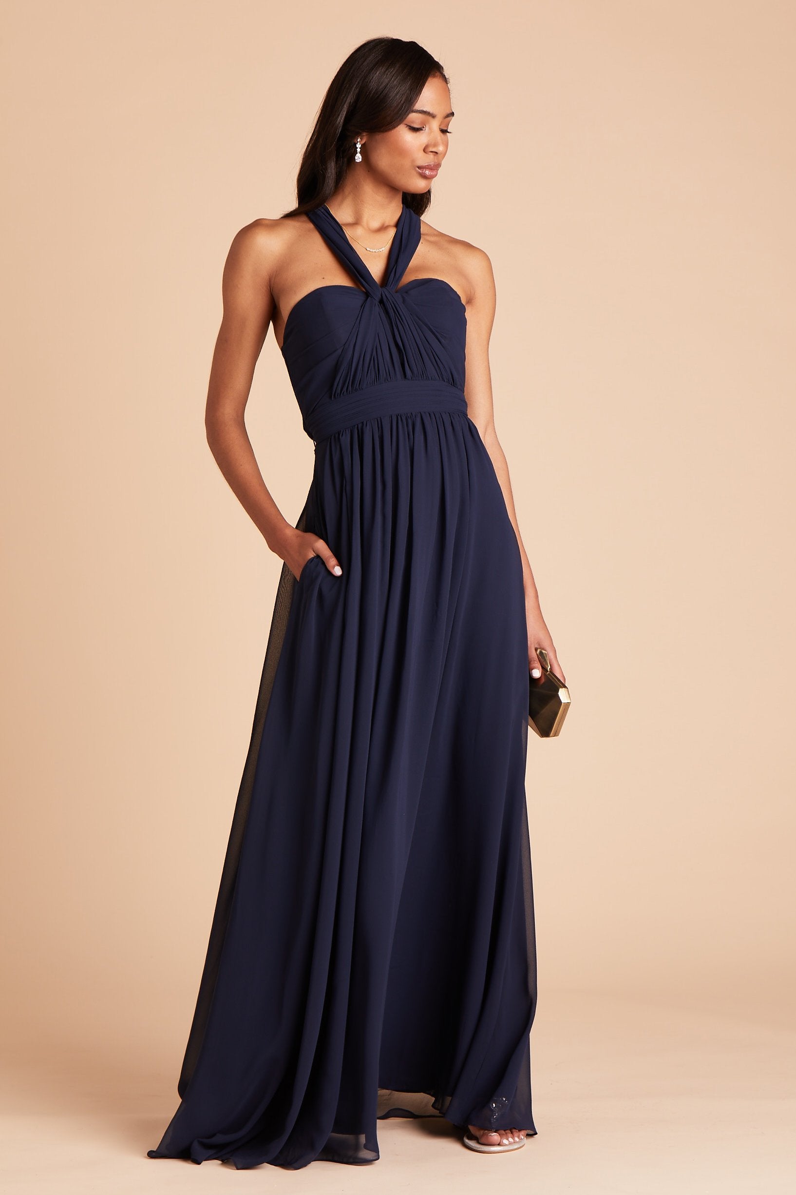Grace convertible bridesmaid dress in navy blue chiffon by Birdy Grey, front view with hand in pocket 