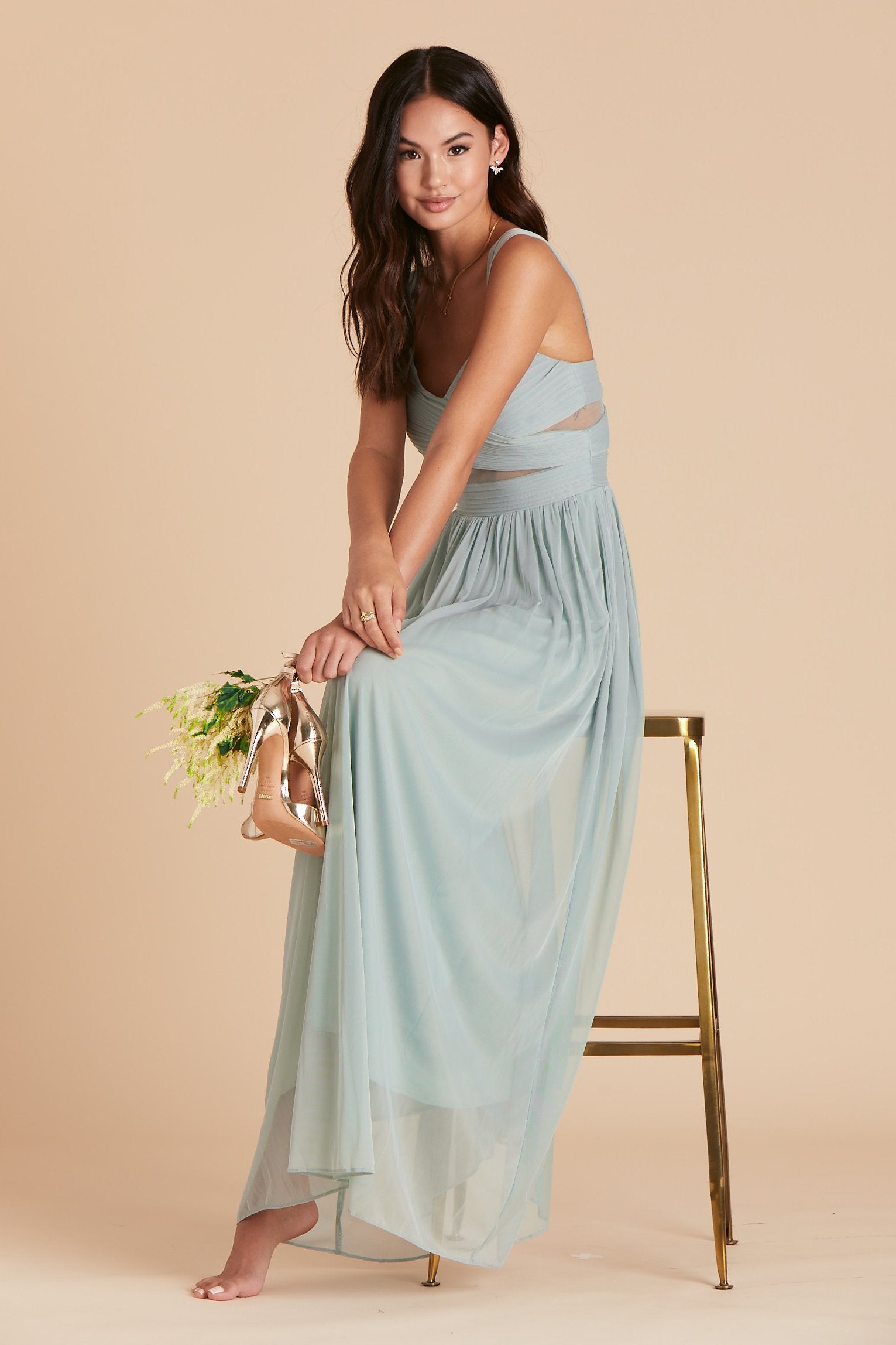 Front view of the floor-length Elsye Bridesmaid Dress in sage mesh by Birdy Grey features a sweetheart neckline and wide straps with a crisscross bust and peekaboo mesh cutouts.