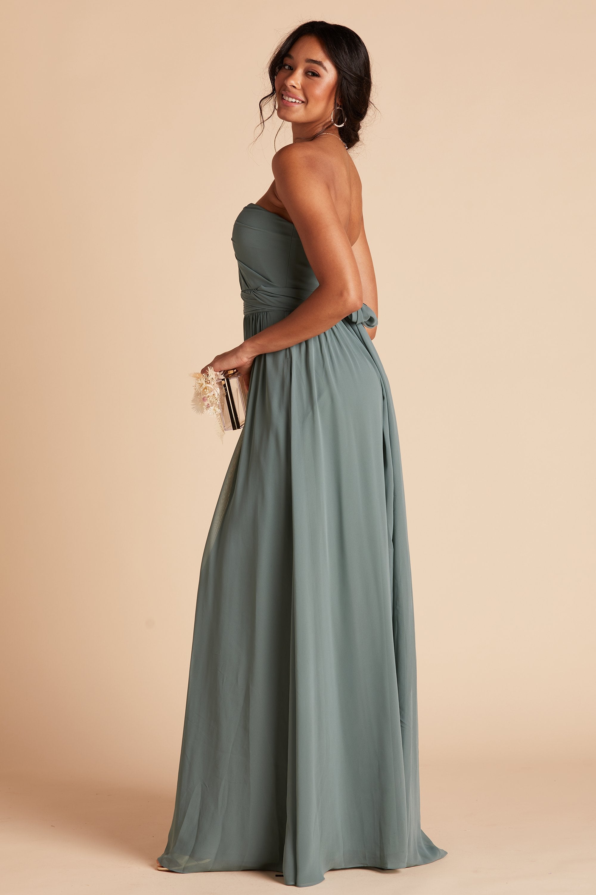 Side view of the Grace Convertible Bridesmaid Dress in sea glass chiffon reveals a fitted bust with a floor-length skirt flowing from the waist.