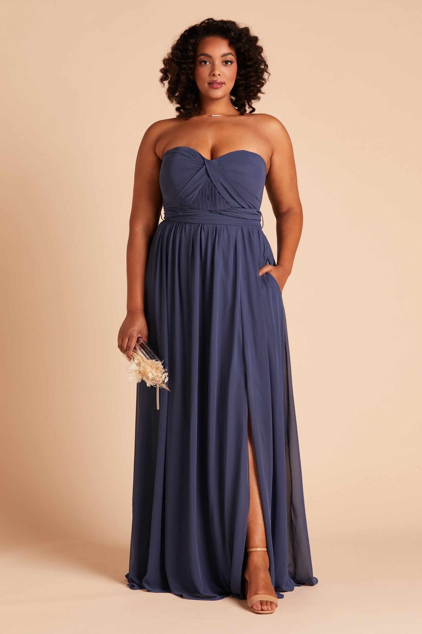 Grace convertible plus size bridesmaid dress with slit in slate blue chiffon by Birdy Grey, front view with hand in pocket