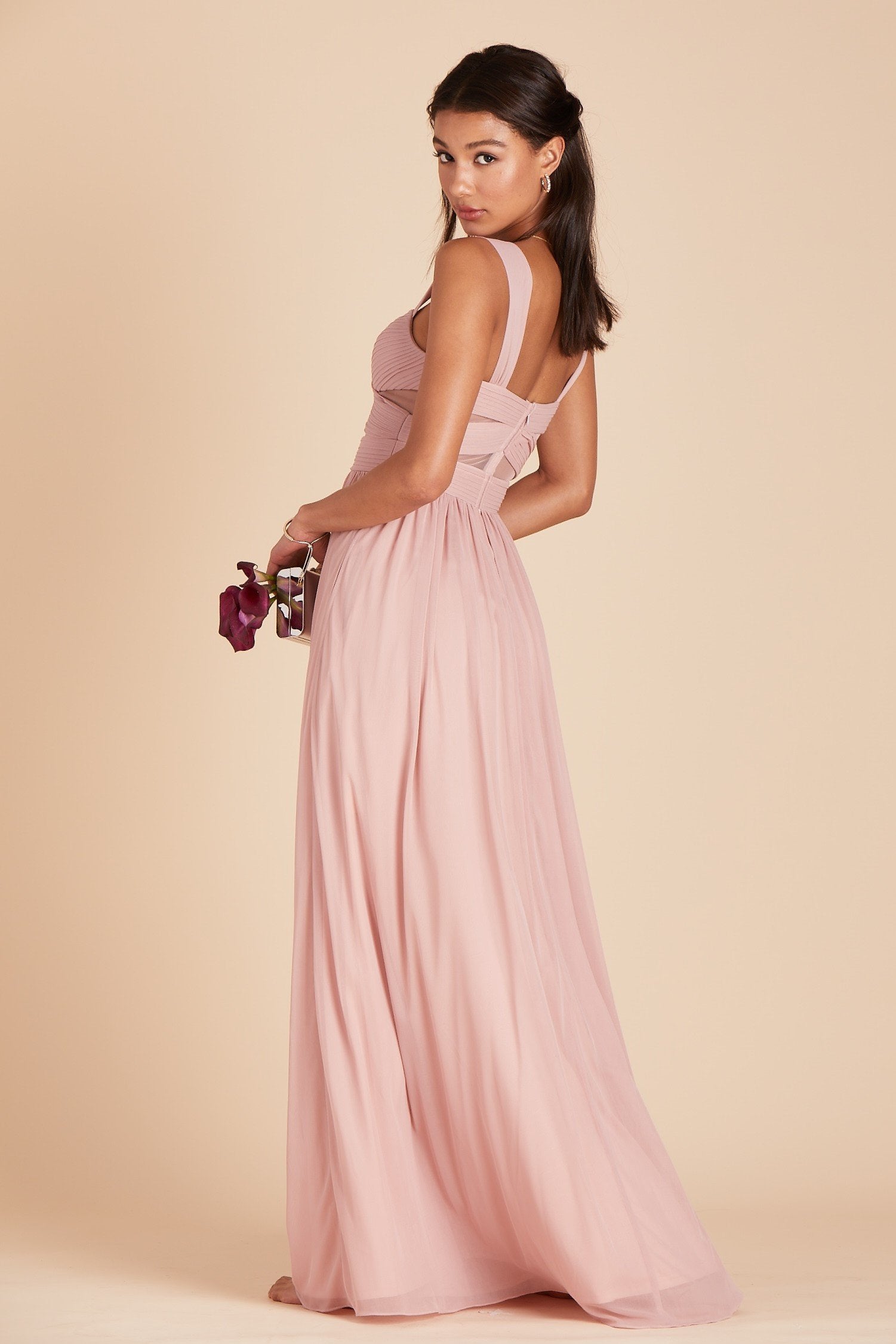 Side view of the Elsye Bridesmaid Dress in dusty rose mesh worn by a slender model with a medium skin tone.