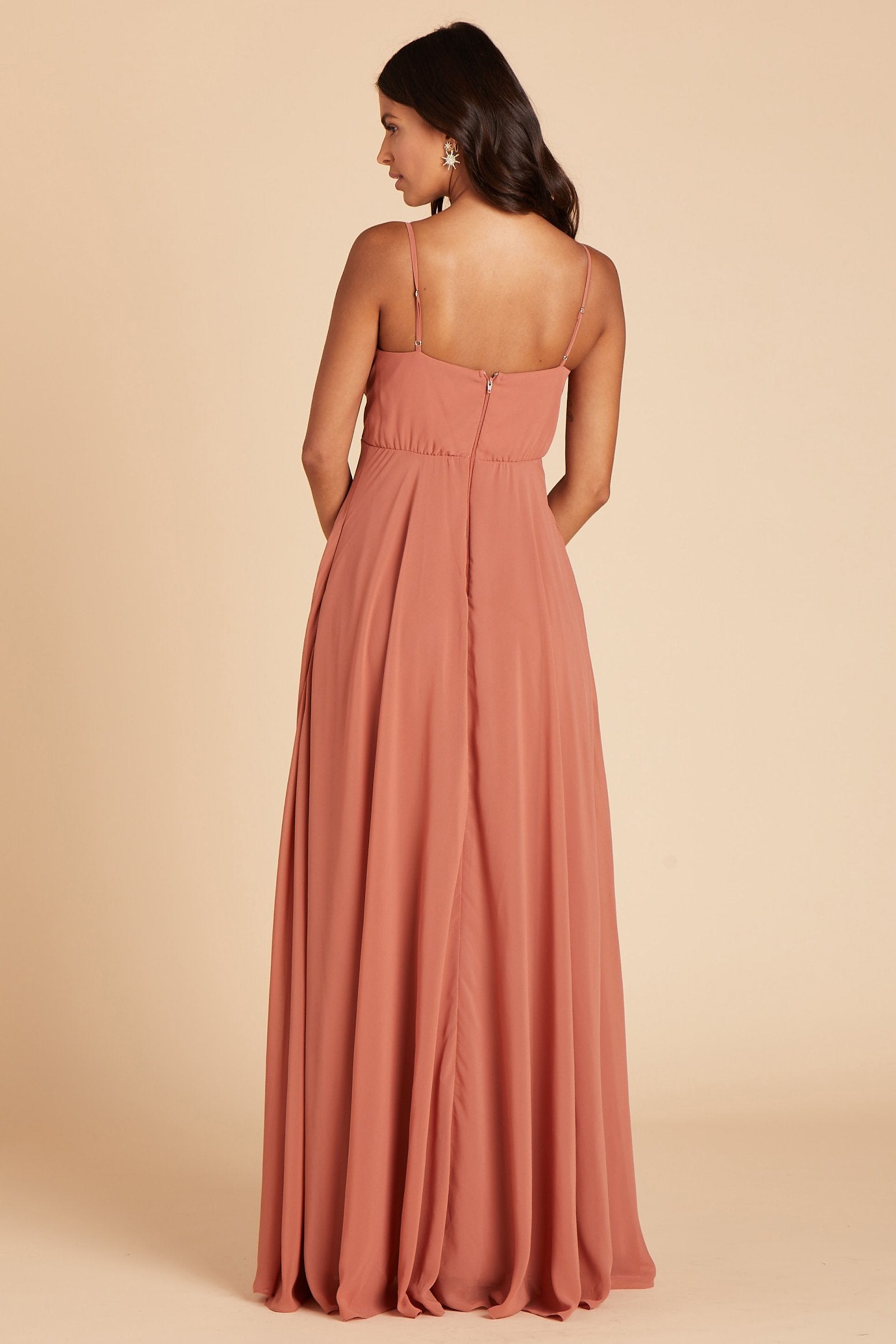 Back view of the Kaia Dress in terracotta chiffon shows the hook and eye closure and the zipper in the center seam of the dress bodice and skirt. 