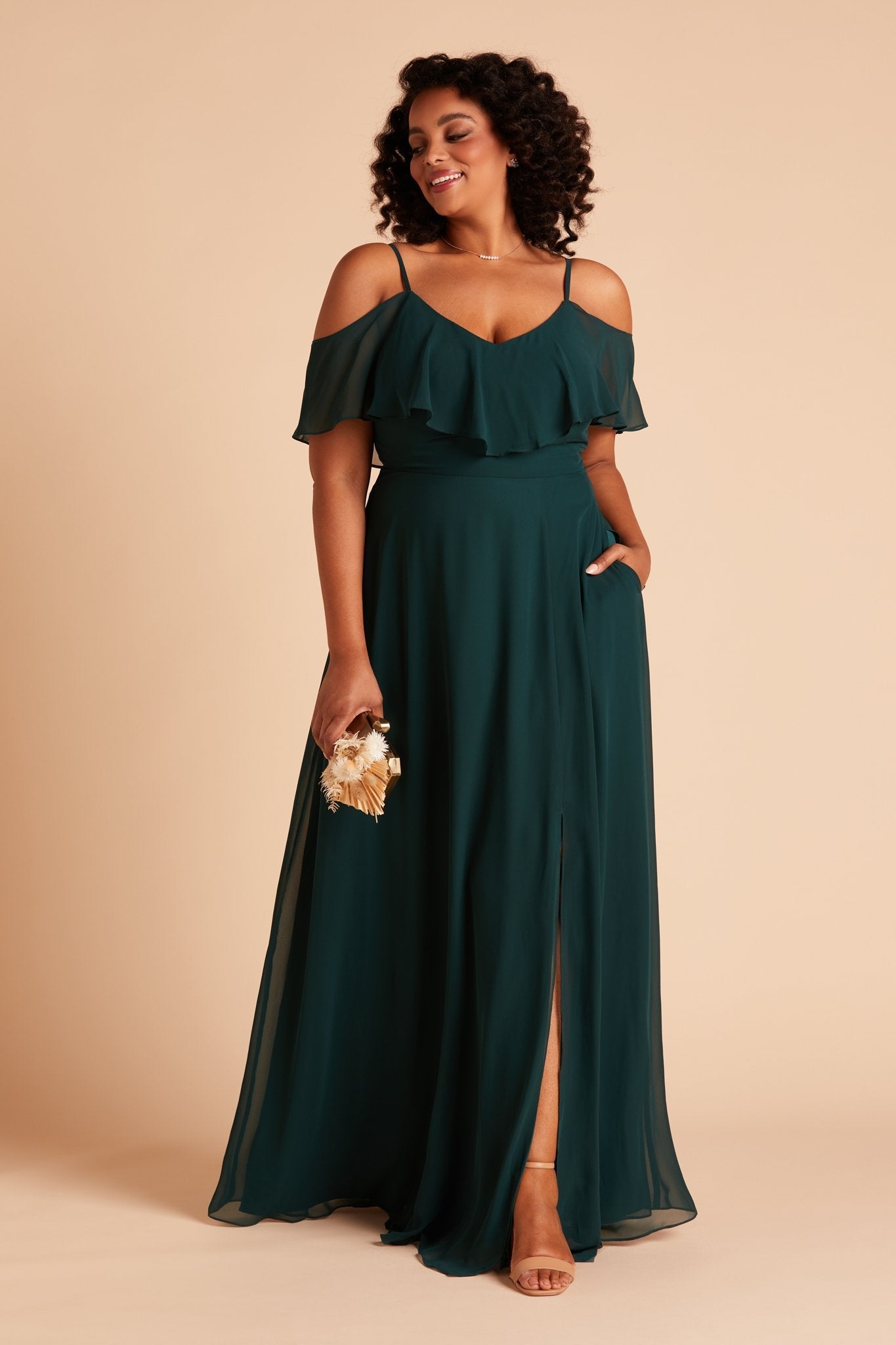 Jane convertible plus size bridesmaid dress with slit in emerald green chiffon by Birdy Grey, front view with hand in pocket
