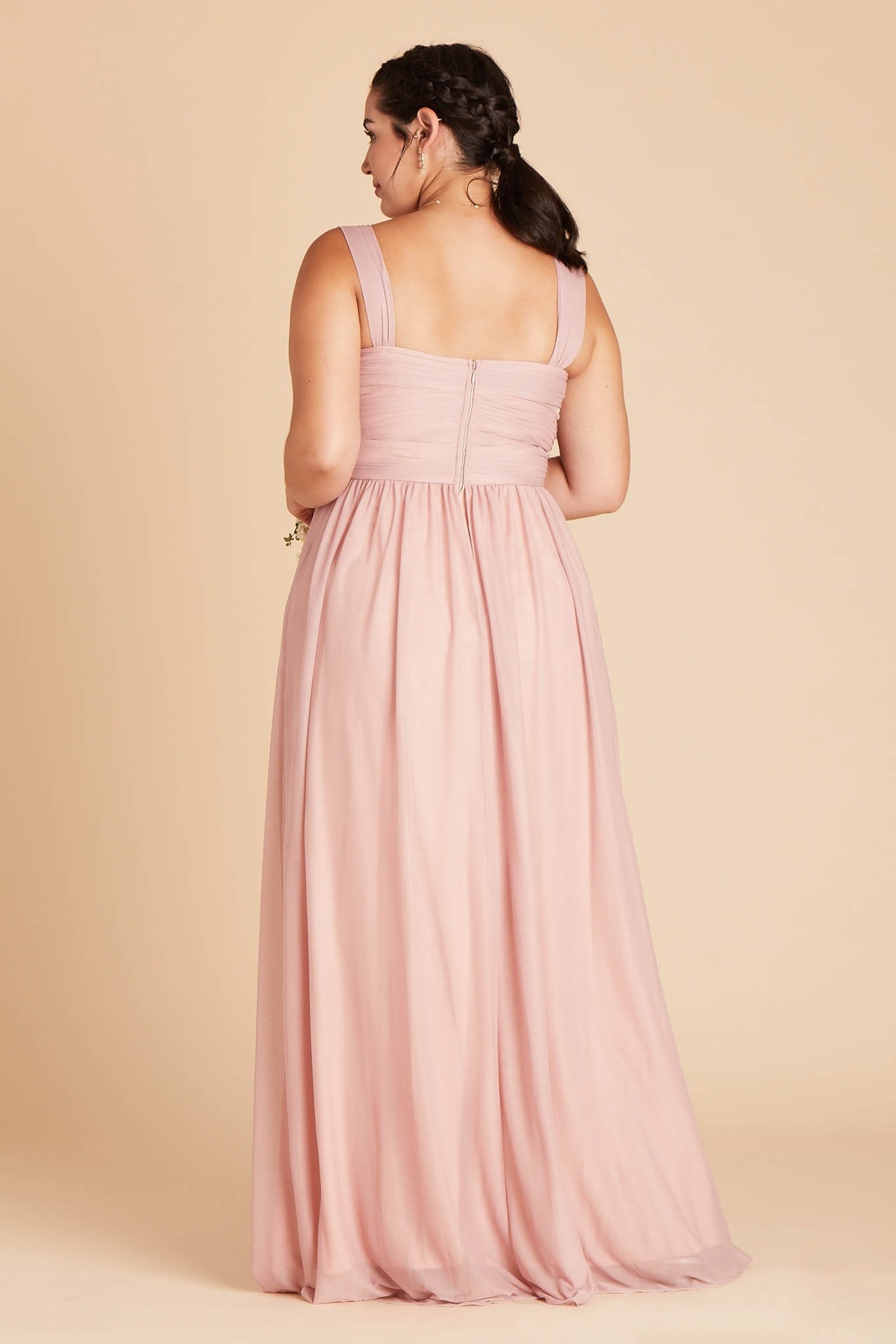 Back view of the Elsye Plus Size Bridesmaid Dress in dusty rose mesh reveals a square cut just below the shoulder blades and the pleated column skirt gracefully flowing to the floor.