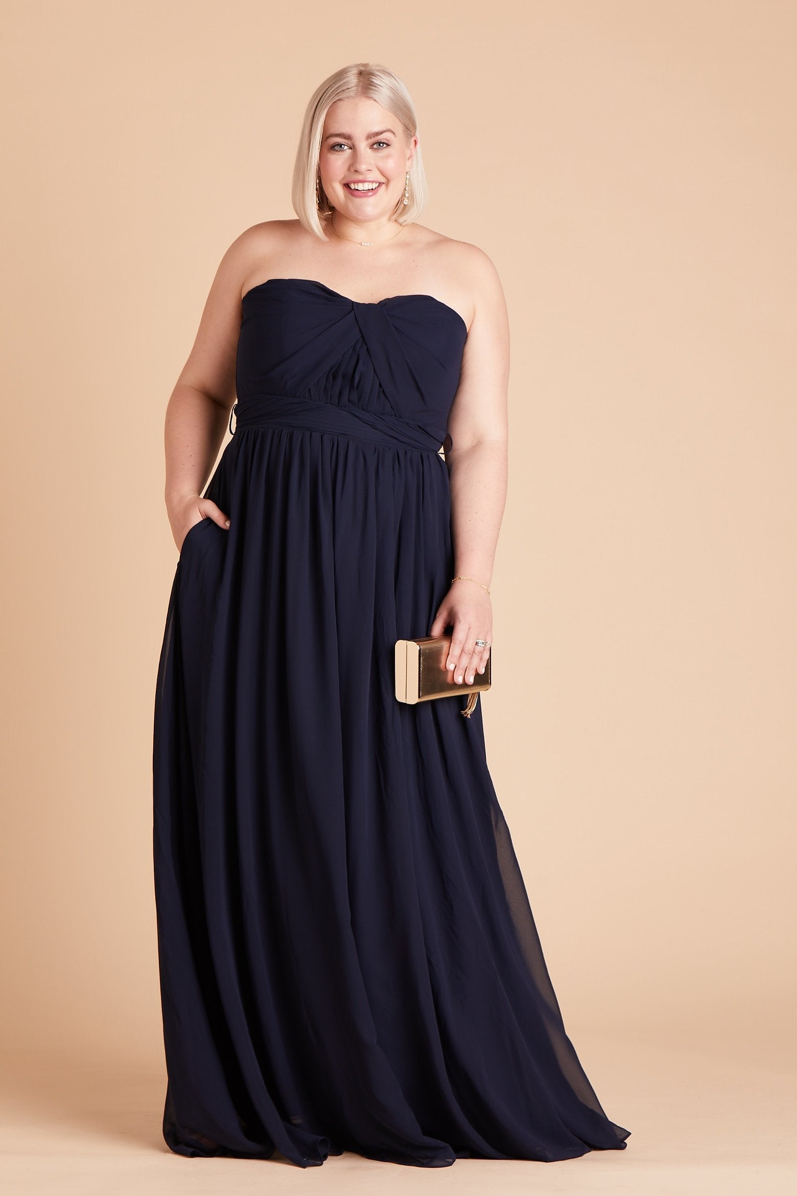 Grace convertible plus size bridesmaid dress in navy blue chiffon by Birdy Grey, front view with hand in pocket