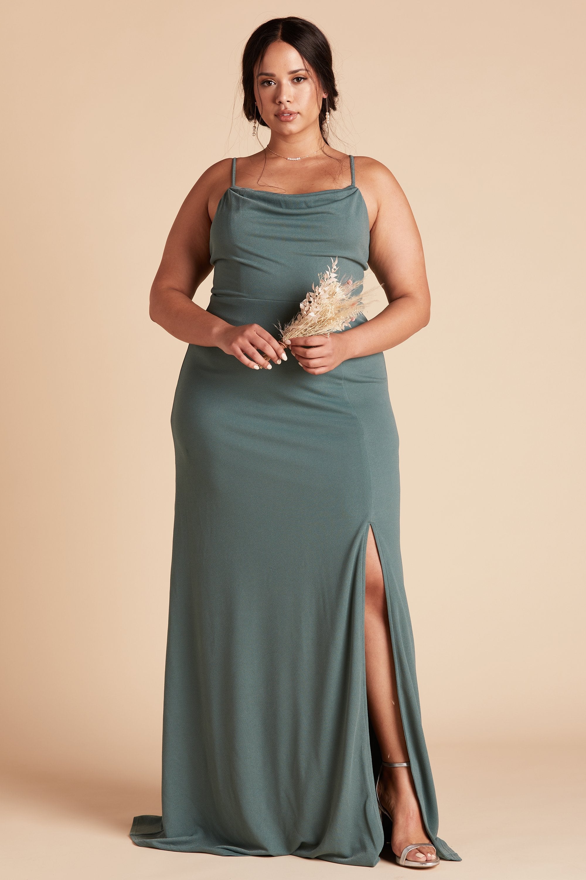 Front view of the floor-length Ash Plus Size Bridesmaid Dress in sea glass crepe by Birdy Grey with a slightly draped cowl neck front. The flowing skirt features a slit over the front left leg.