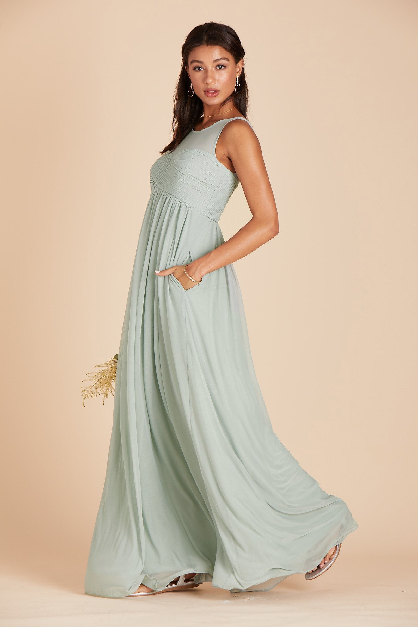 Ryan bridesmaid dress in sage green chiffon by Birdy Grey, side view with hand in pocket