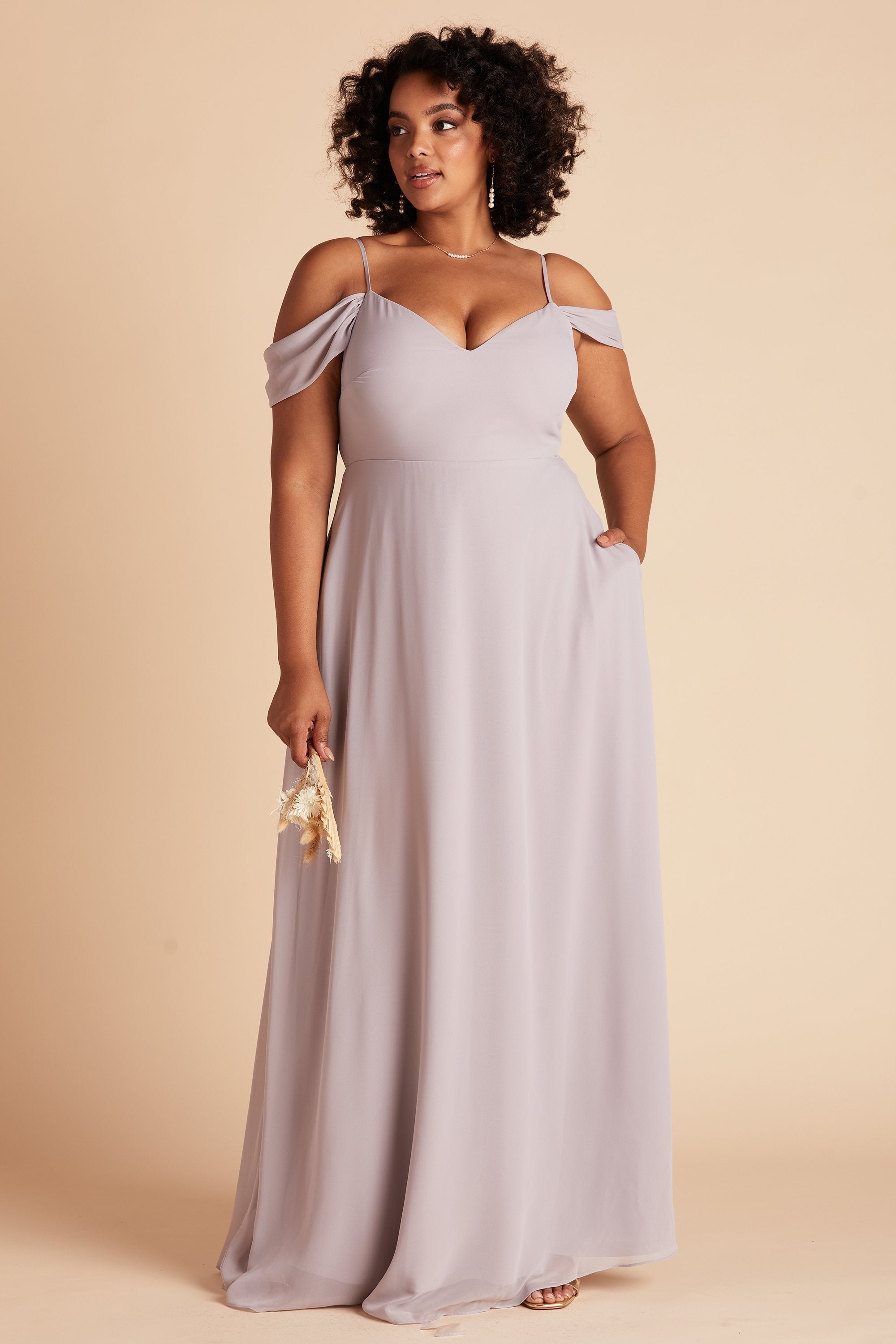 Devin convertible plus size bridesmaids dress in lilac purple chiffon by Birdy Grey, front view with hand in pocket