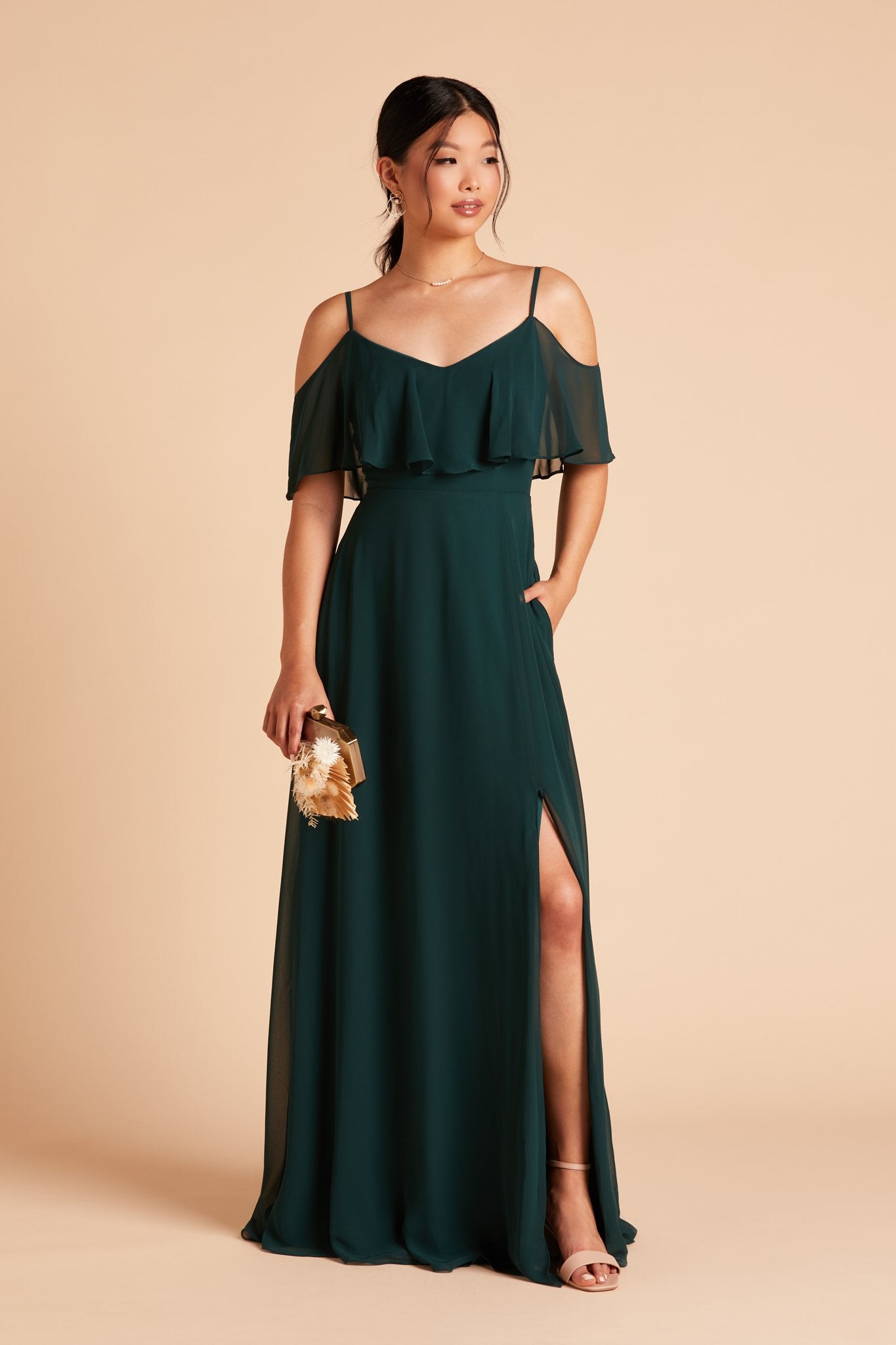 Jane convertible bridesmaid dress with slit in emerald green chiffon by Birdy Grey, front view with hand in pocket