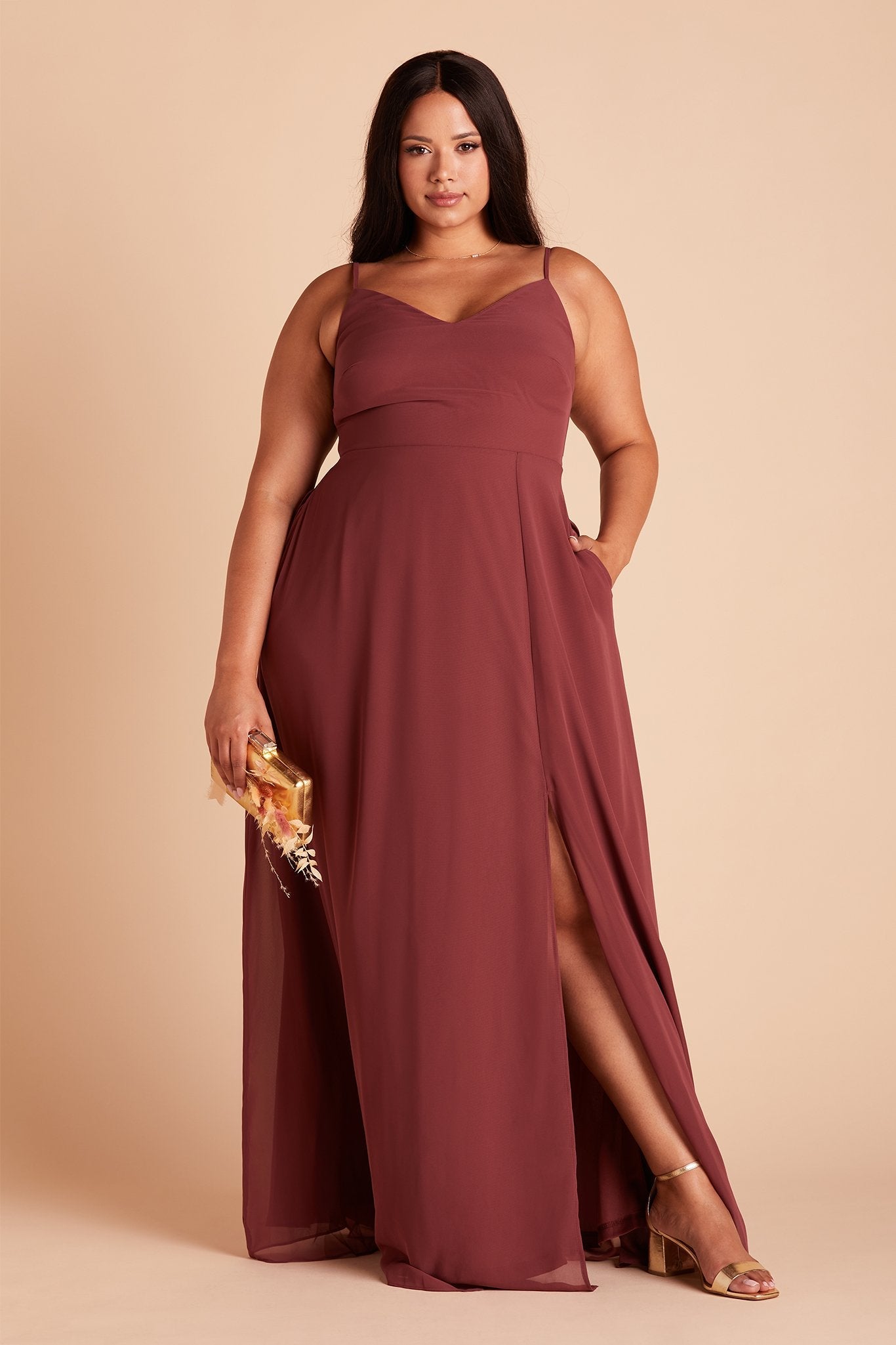 Devin convertible plus size bridesmaids dress with slit in rosewood chiffon by Birdy Grey, front view with hand in pocket