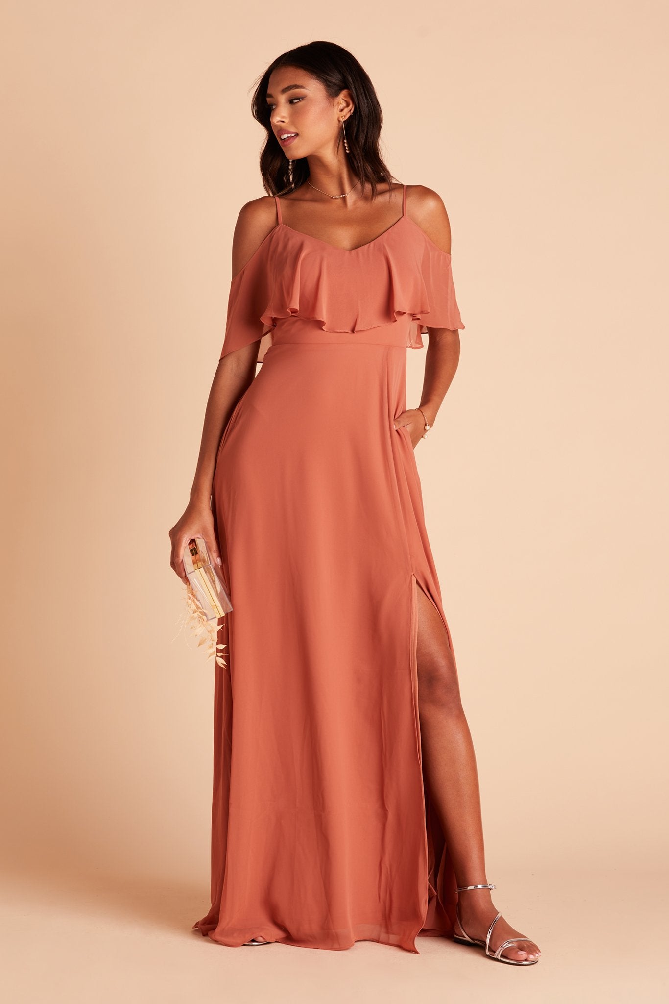 Jane convertible bridesmaid dress with slit in terracotta orange chiffon by Birdy Grey, front view with hand in pocket