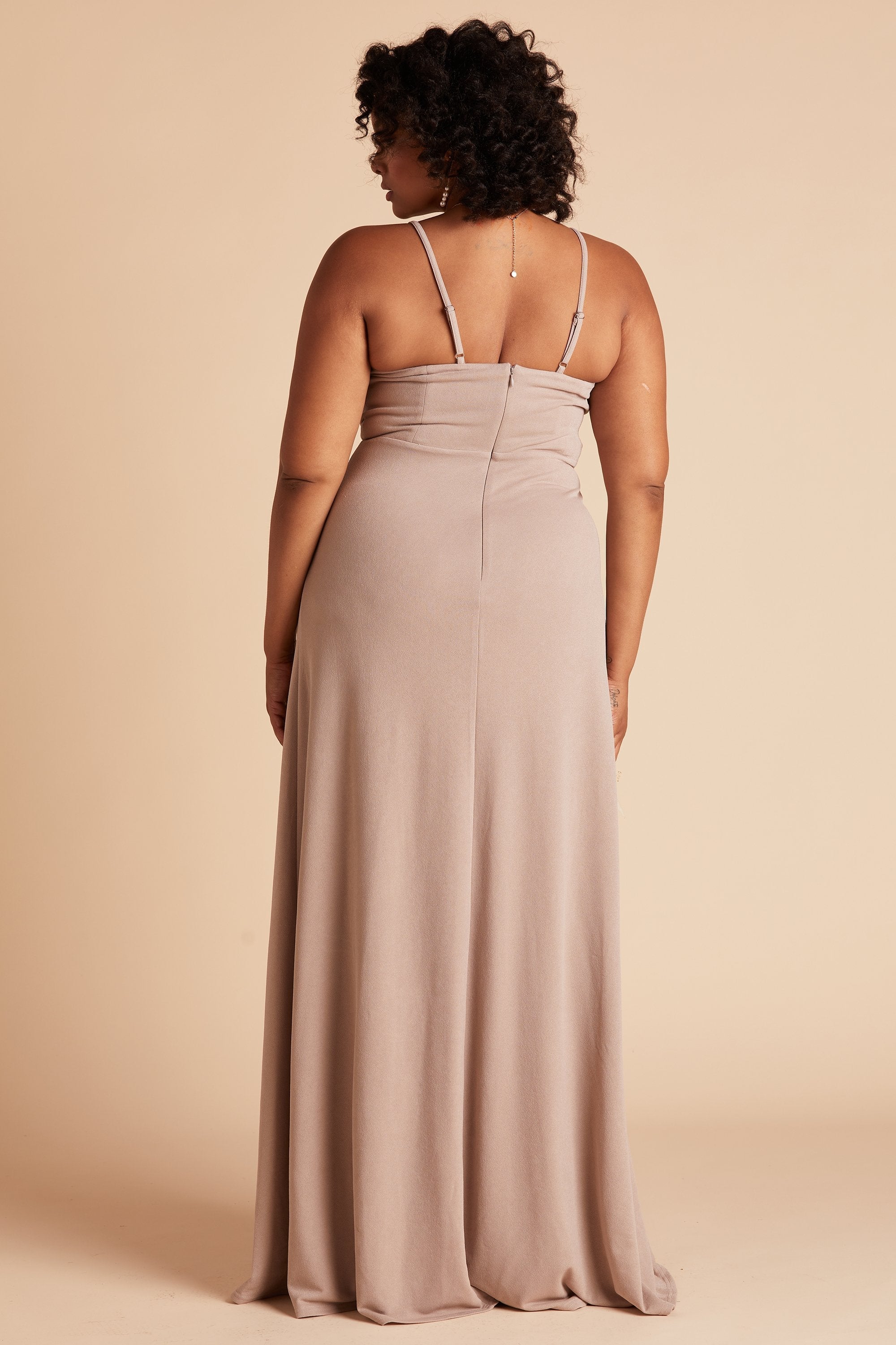 Side view of the floor-length Ash Plus Size Bridesmaid Dress in taupe crepe features a fitted bust and waist with a flowing skirt that drapes to the floor.