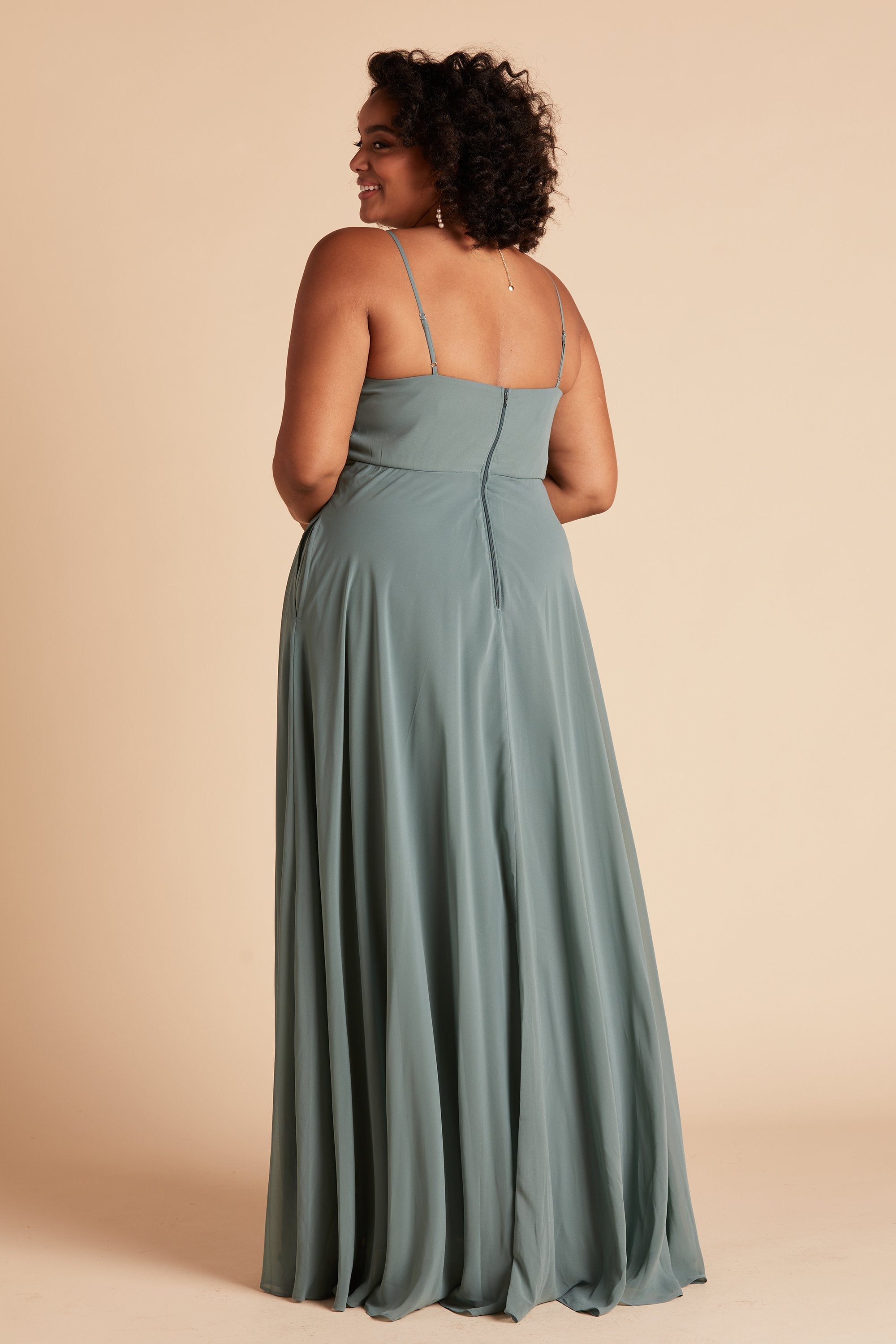 Back view of the Kaia Dress Curve in sea glass chiffon shows the hook and eye closure and hidden zipper in the center seam of the dress bodice and skirt.