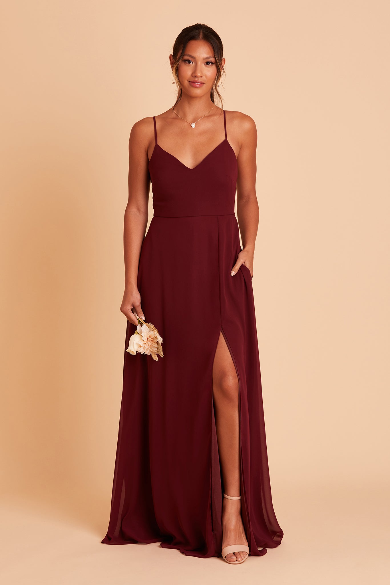 Adelle bridesmaid dress with slit in cabernet burgundy chiffon by Birdy Grey, hand in pocket, front view