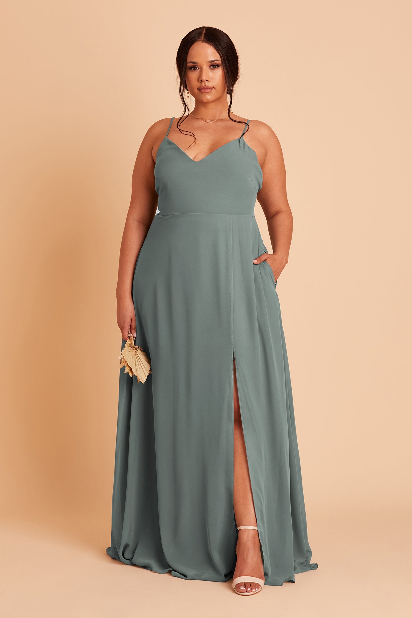Adelle plus size bridesmaid dress with slit in sea glass green chiffon by Birdy Grey, hand in pocket, front view