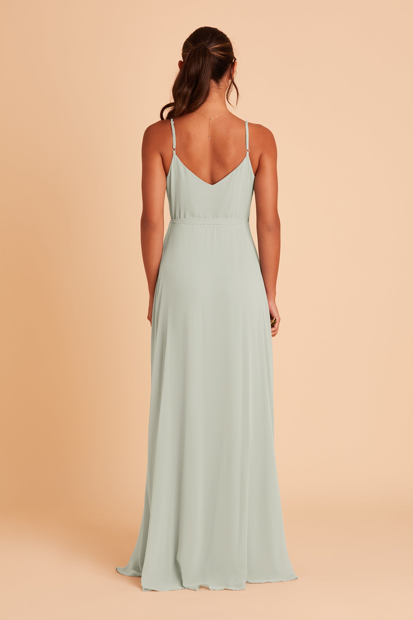 Back view of the Cindy Bridesmaid Dress in sage chiffon features a slip-style back with a gracefully flowing full-length skirt.
