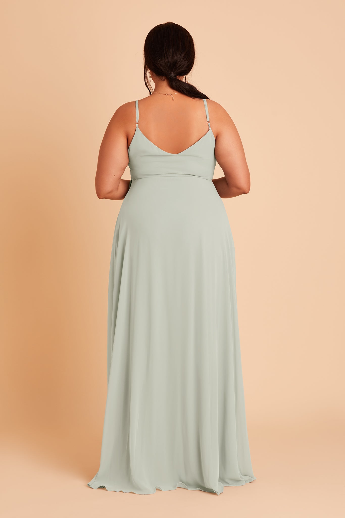 Back view of the Cindy Plus Size Bridesmaid Dress in sage chiffon features a slip-style back with a gracefully flowing floor-length skirt.