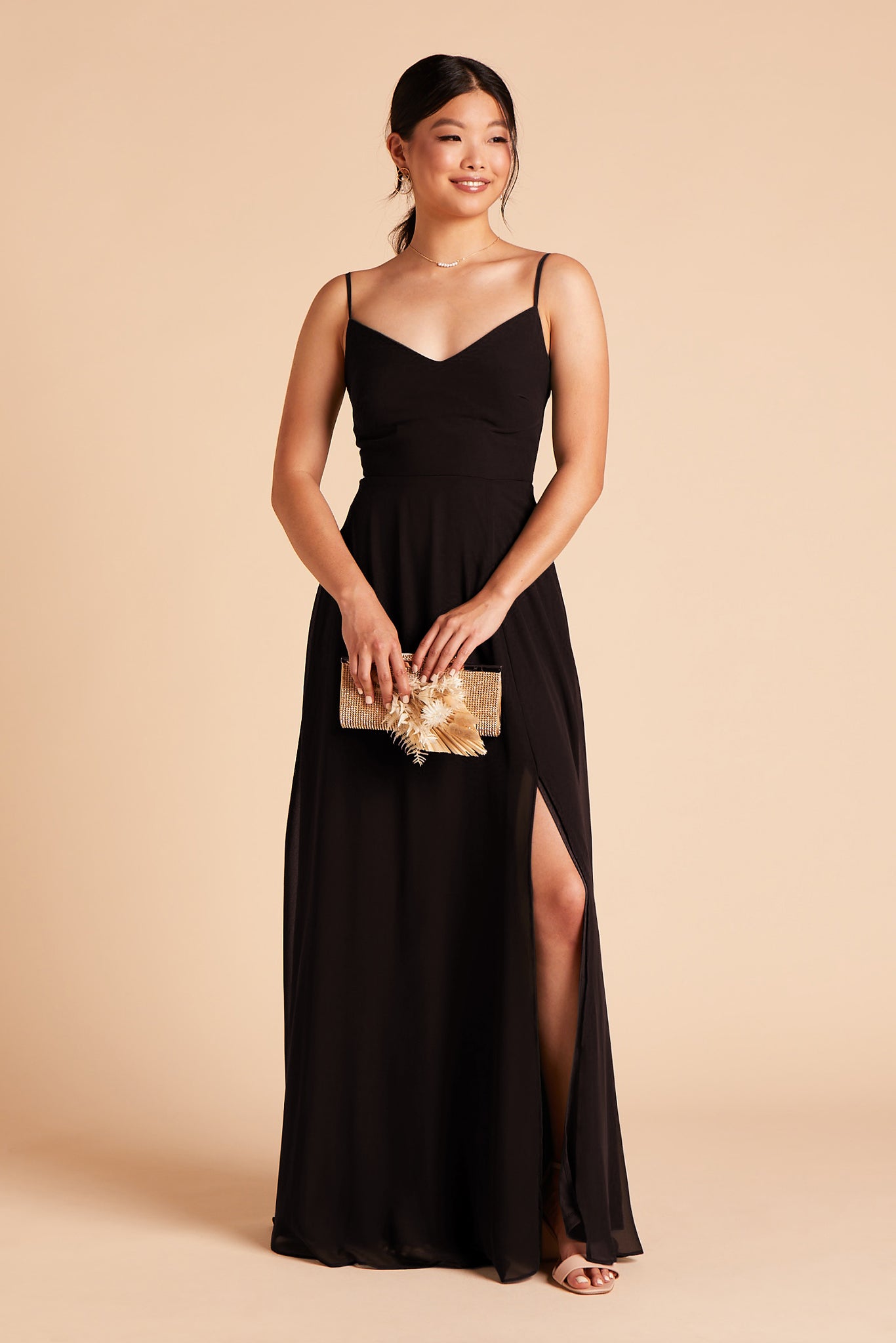 Long floor-sweeping black chiffon bridesmaid dress with slit and a V-neckline and no sleeves