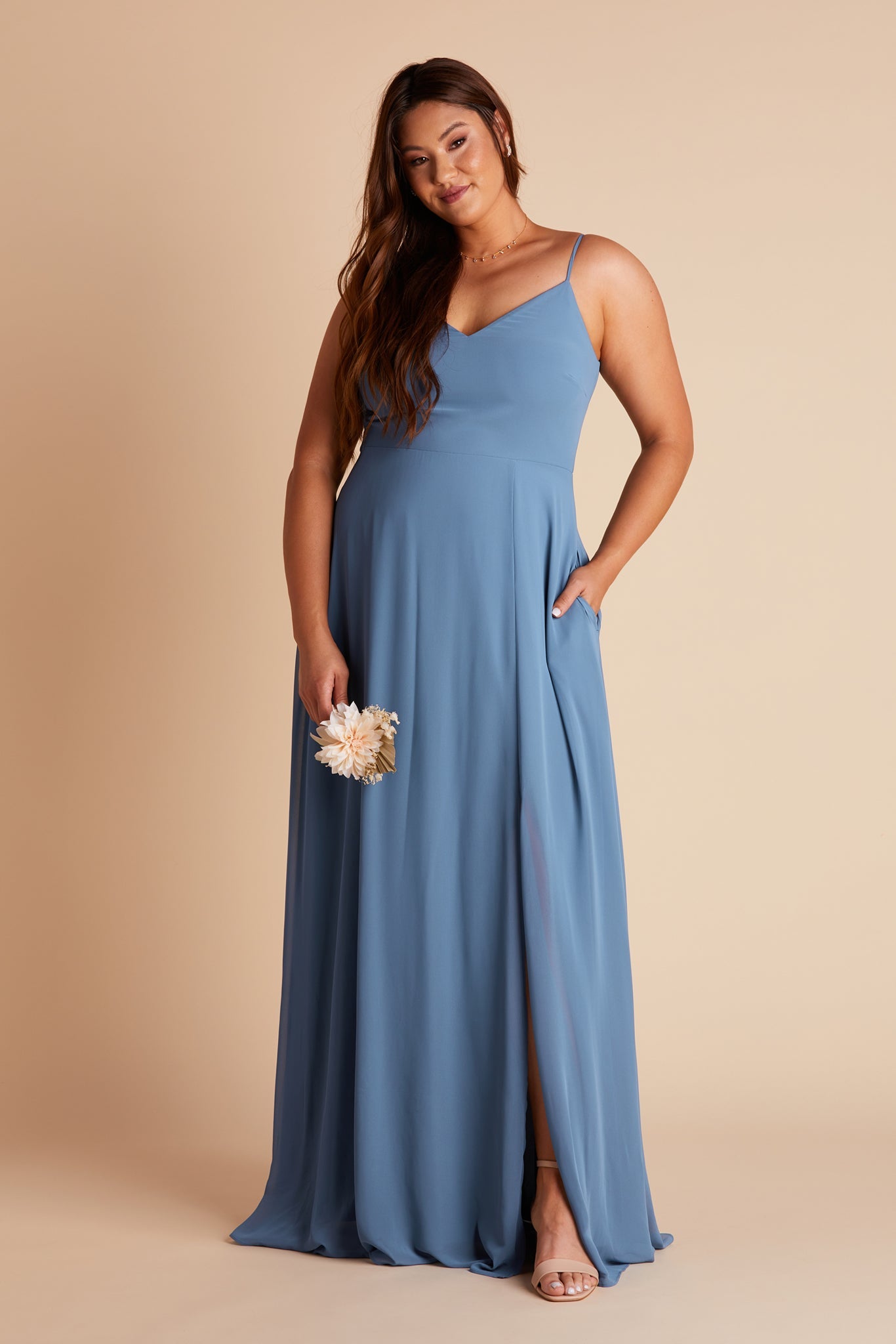 Devin convertible plus size bridesmaids dress with slit in twilight blue chiffon by Birdy Grey, front view with hand in pocket