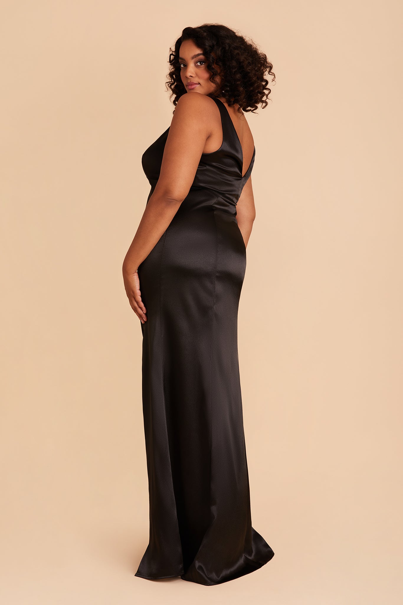 Gloria plus size bridesmaid dress with slit in black satin by Birdy Grey, side view